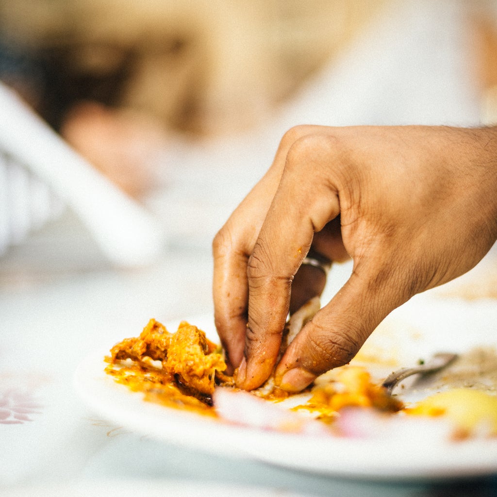 A person eats with their hands in India