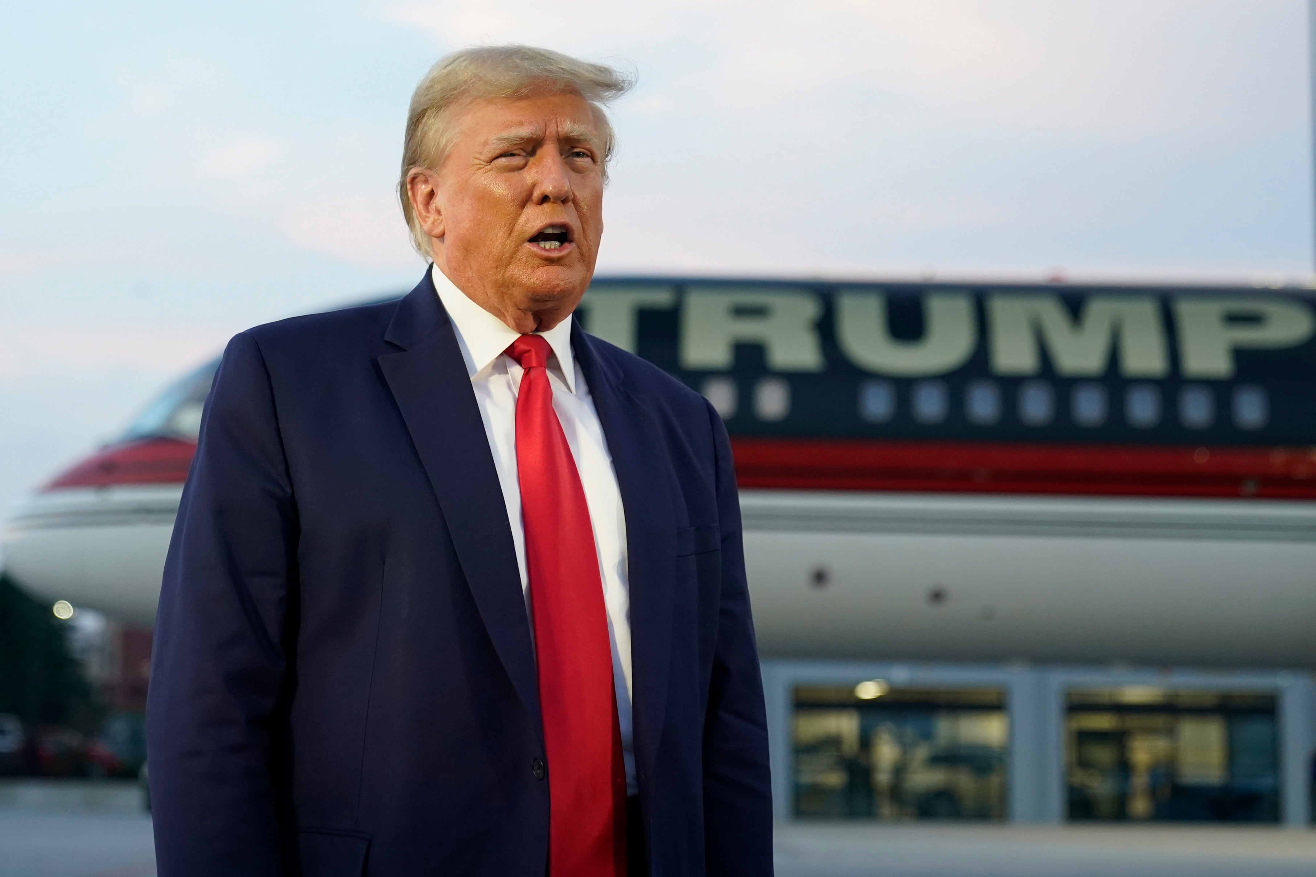 Former President Donald Trump speaks with reporters before departure from Hartsfield-Jackson Atlanta International Airport, Thursday, Aug. 24, 2023, in Atlanta.