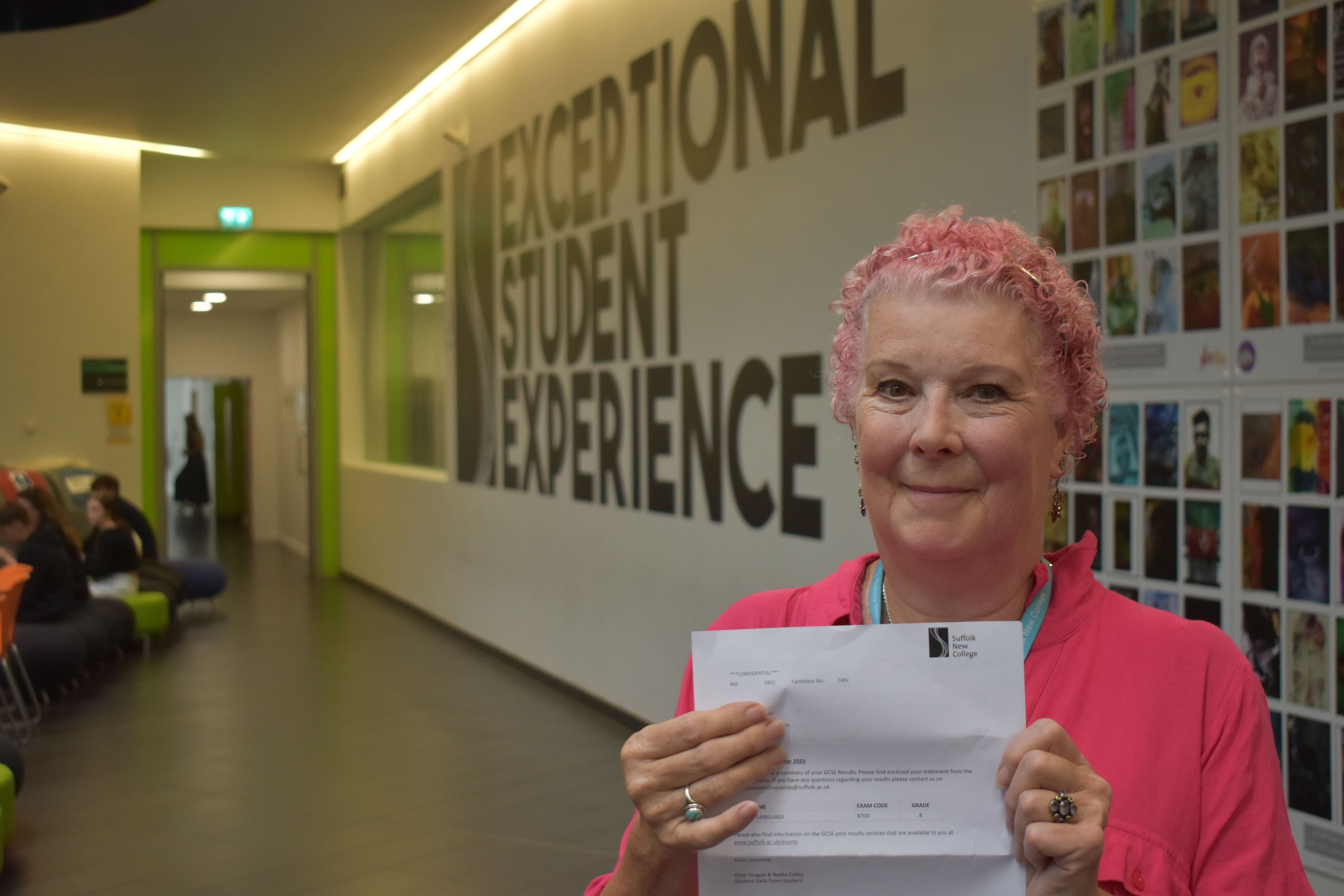 Anne Blowers, 74, displays her certificate after passing her GCSE English language exam at Suffolk New College (Suffolk New College/PA)