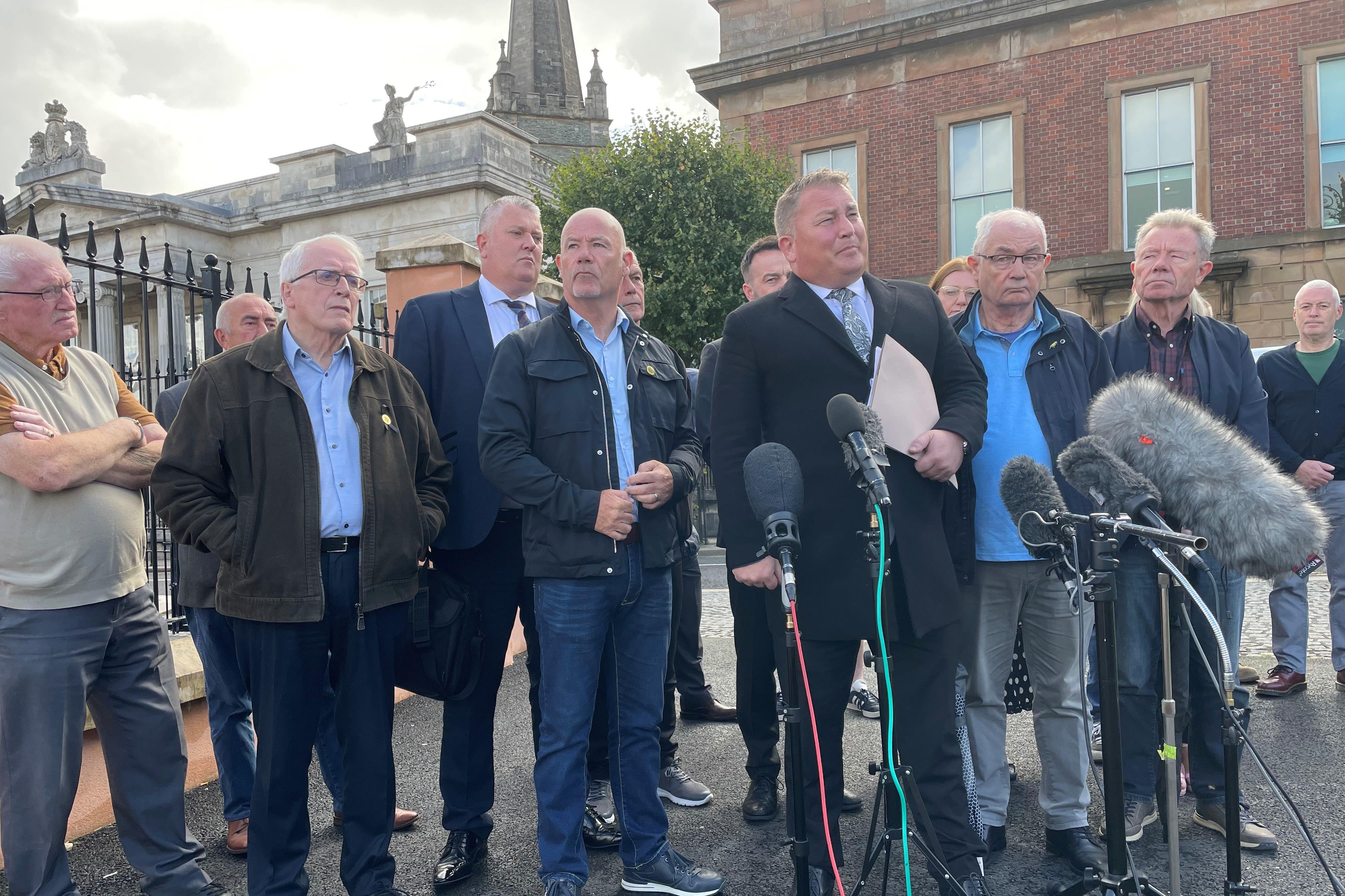 Lawyer Ciaran Shiels with families of Bloody Sunday victims speak to the media (Jonathan McCambridge/PA)