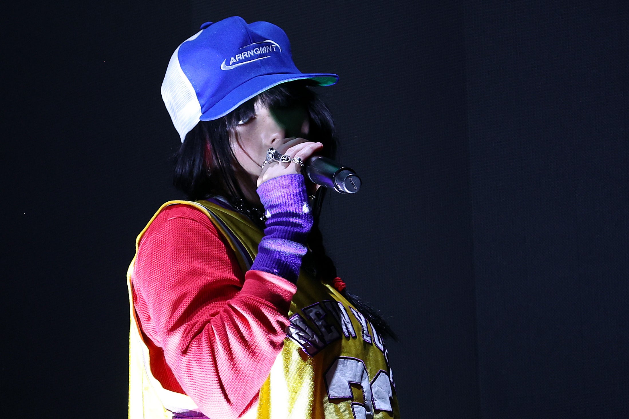 Dressed in bright baseball garb, Billie Eilish performs at this year’s Reading Festival