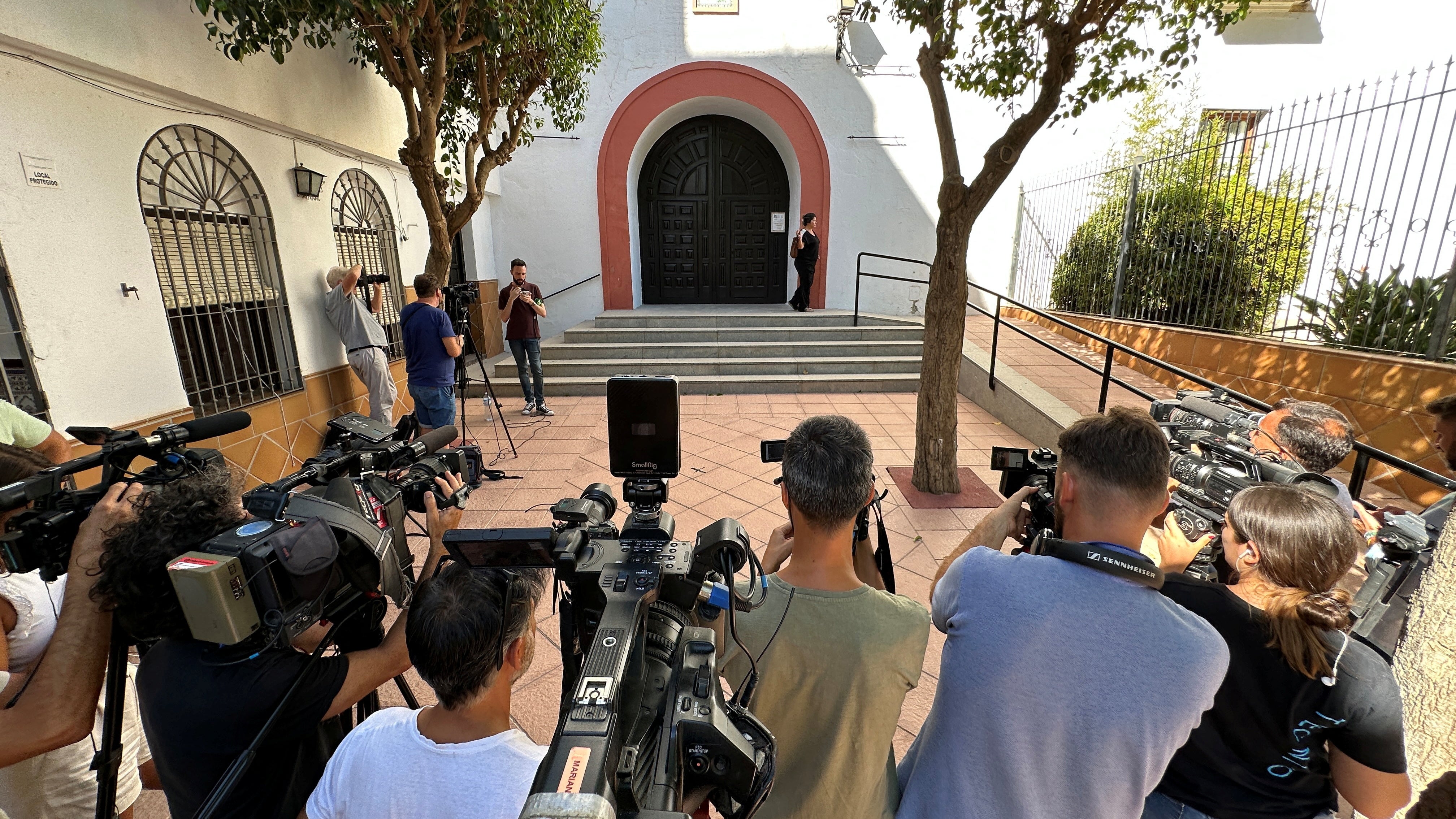 Media are pictured outside the church in Motril