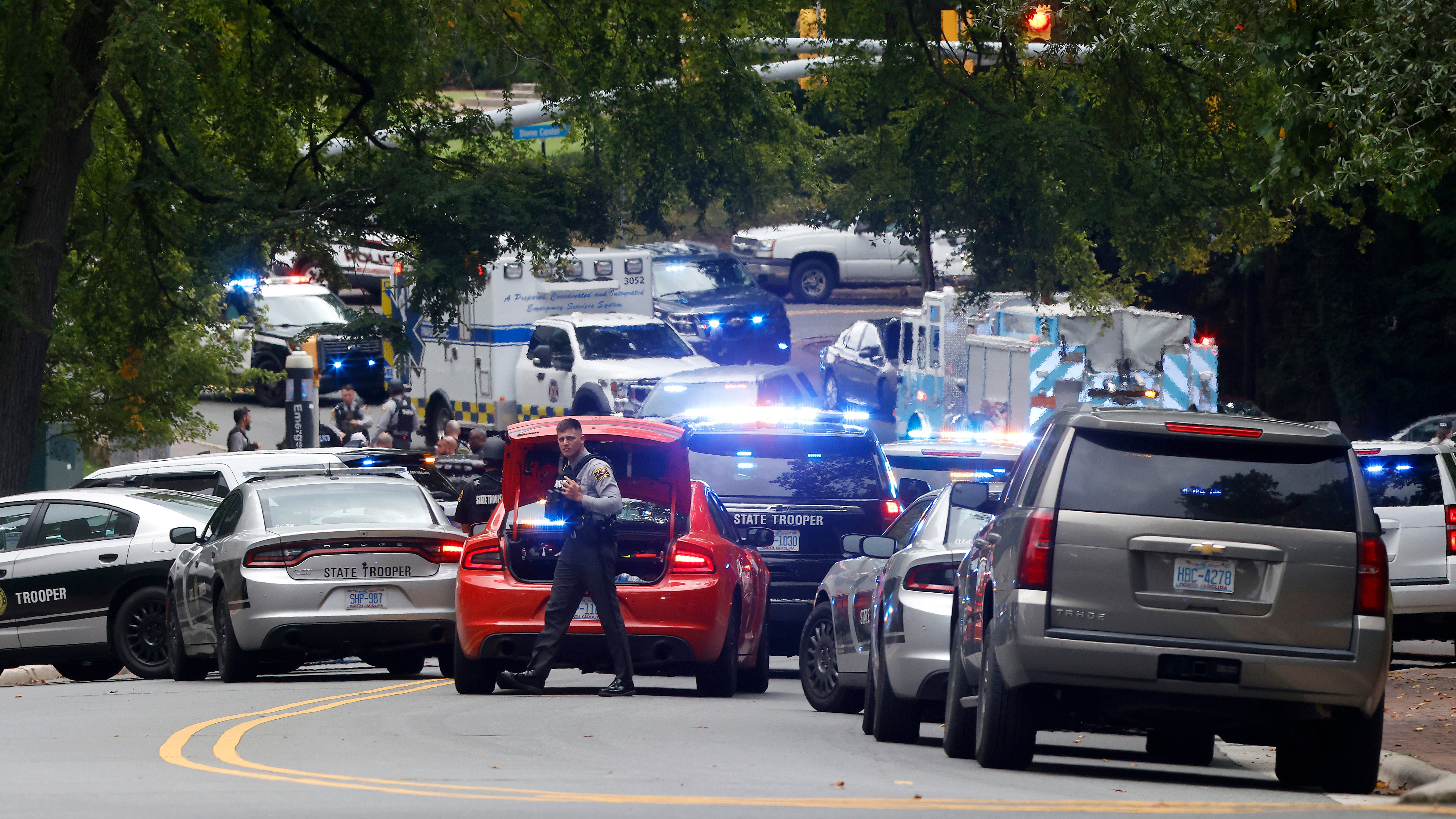 Law enforcement and first responders gather on South Street near the Bell Tower on the campus