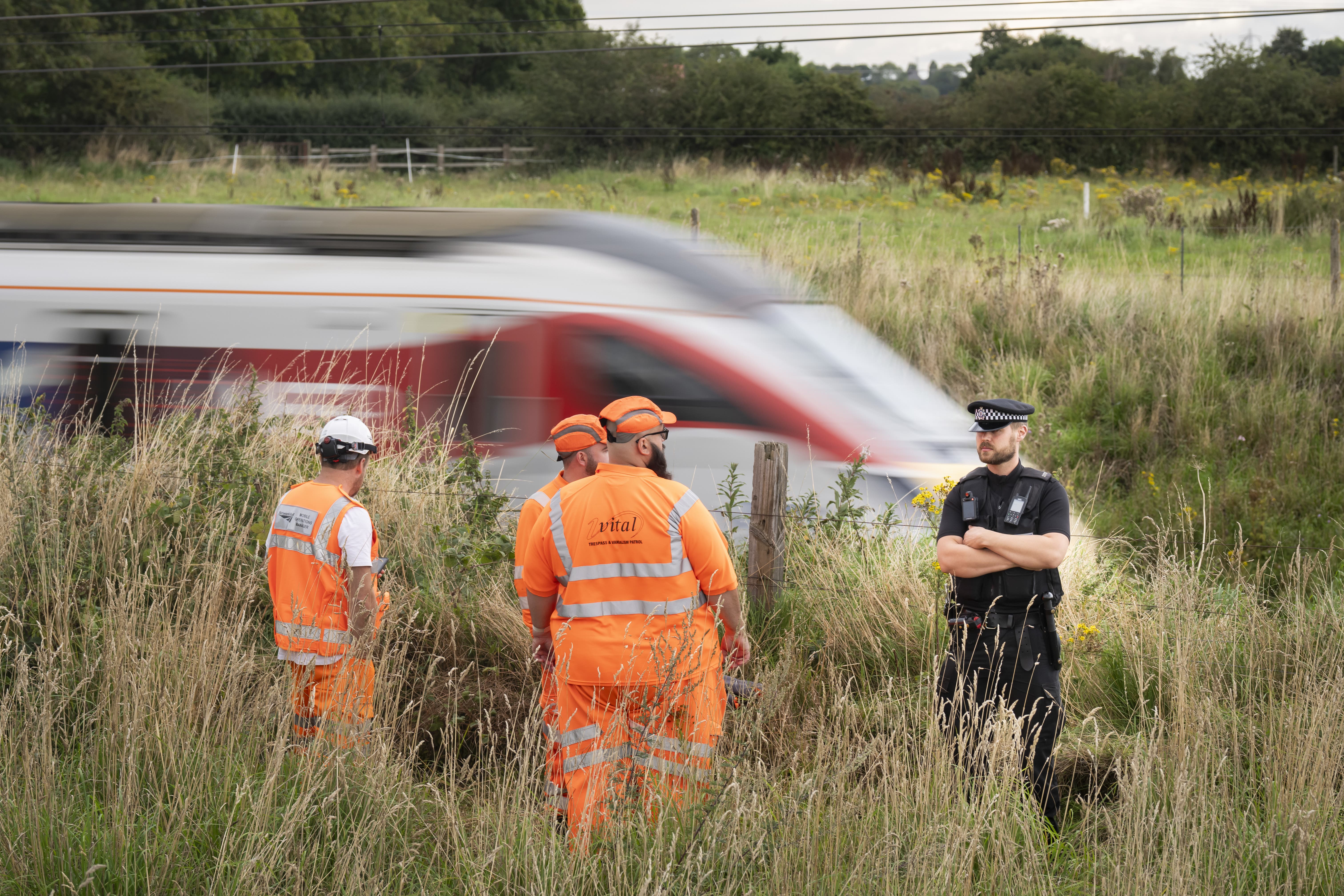 Police and railway workers near the scene in Balderton, near Newark-on-Trent (Danny Lawson/PA)