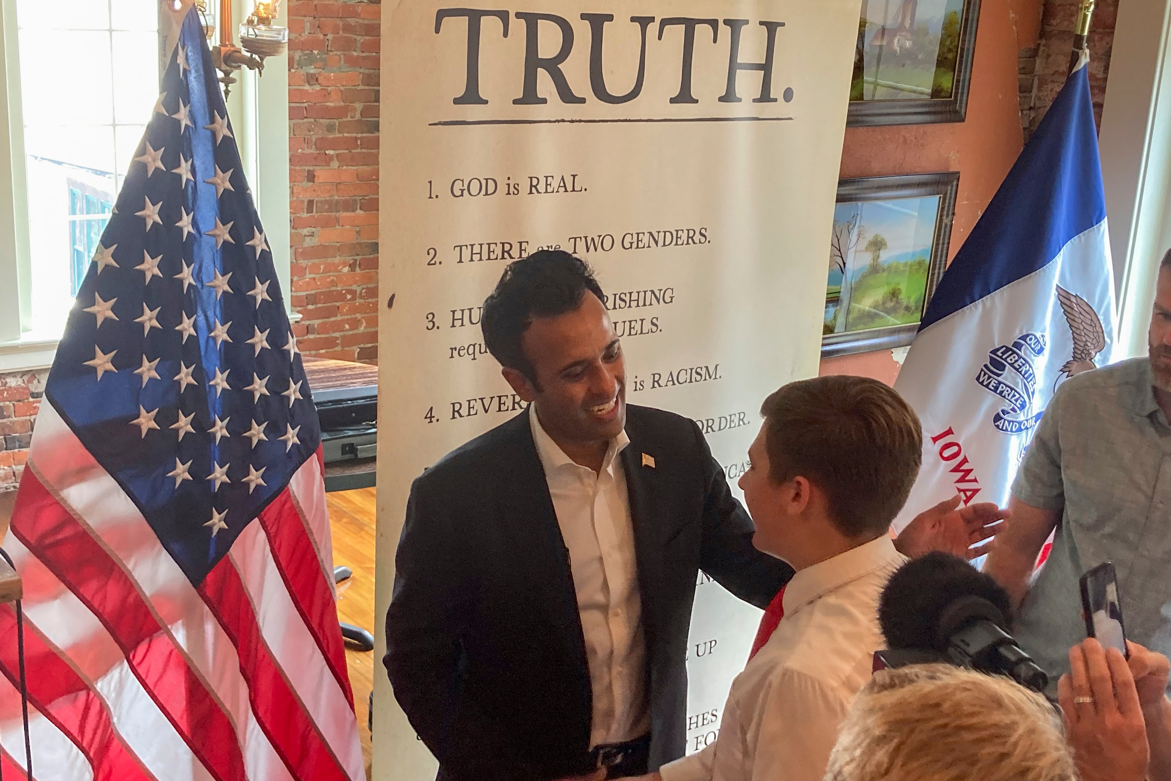 Ramaswamy greets voters at a campaign stop in Pella, Iowa