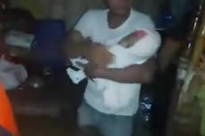 Coastguard rescues family with baby as Super Typhoon Saola floods homes in the Philippines