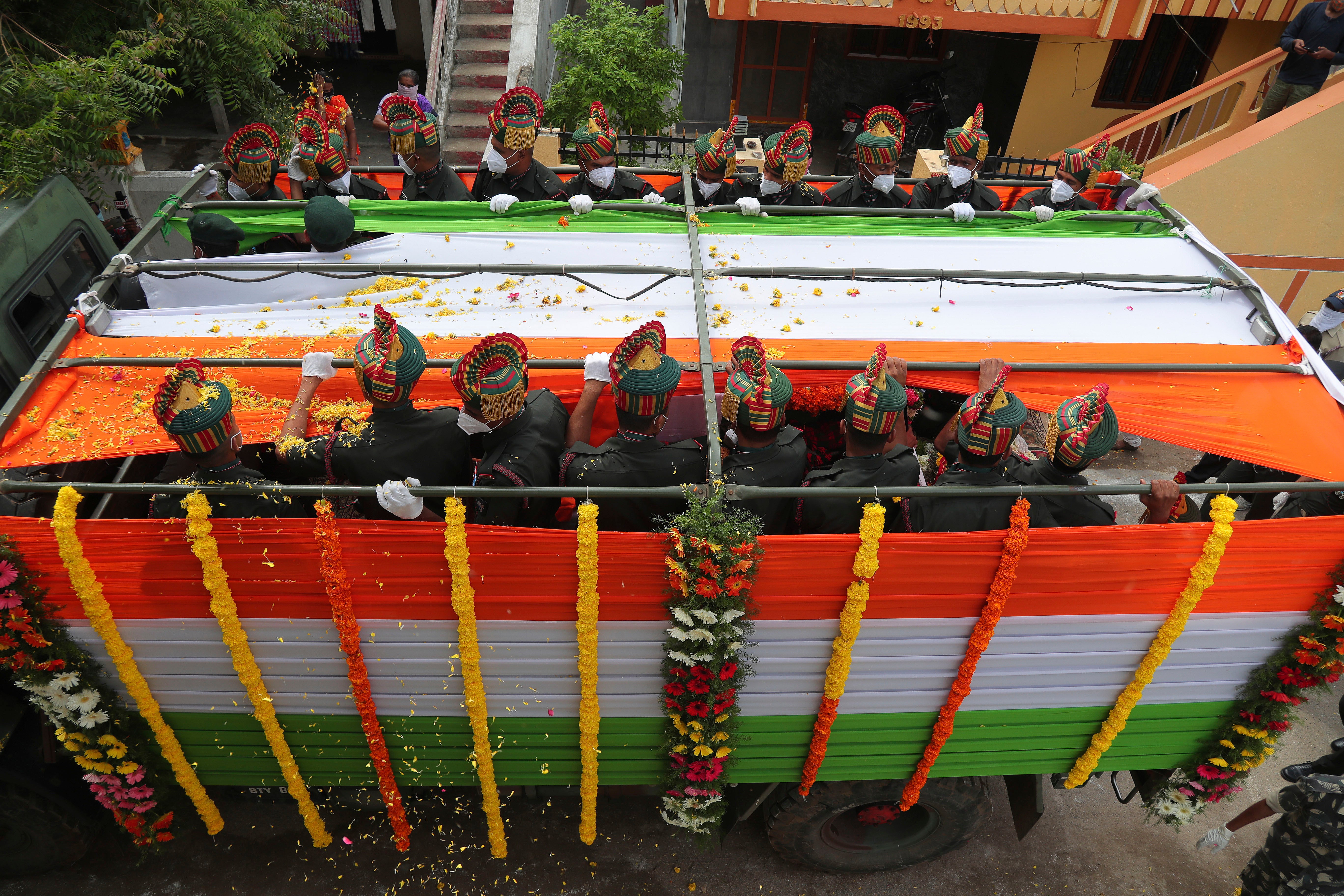 A truck carries the coffin of an Indian army officer killed in a 2020 border clash between Indian and Chinese soldiers in Ladakh