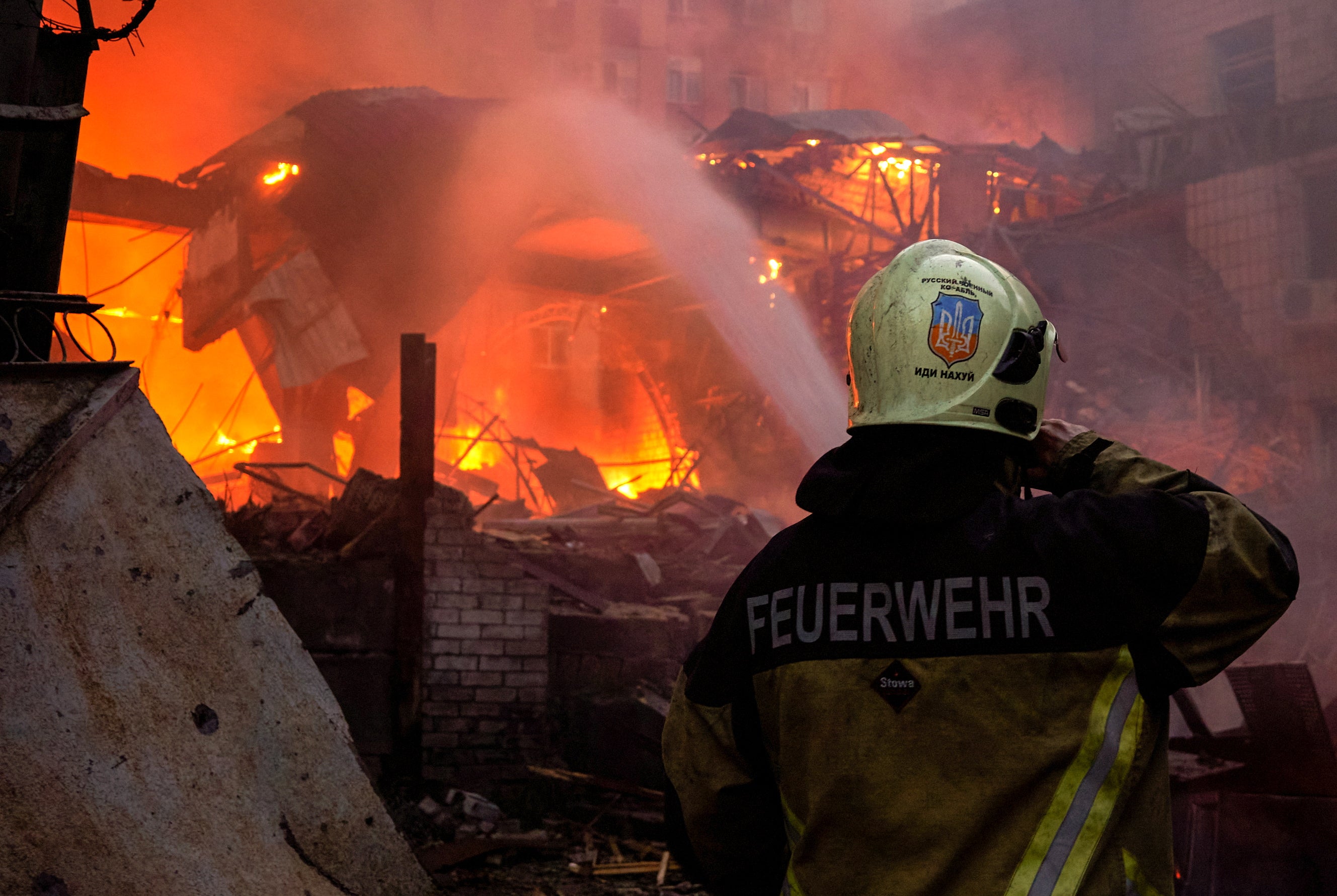 A firefighter works at the site of a missile strike in Kyiv