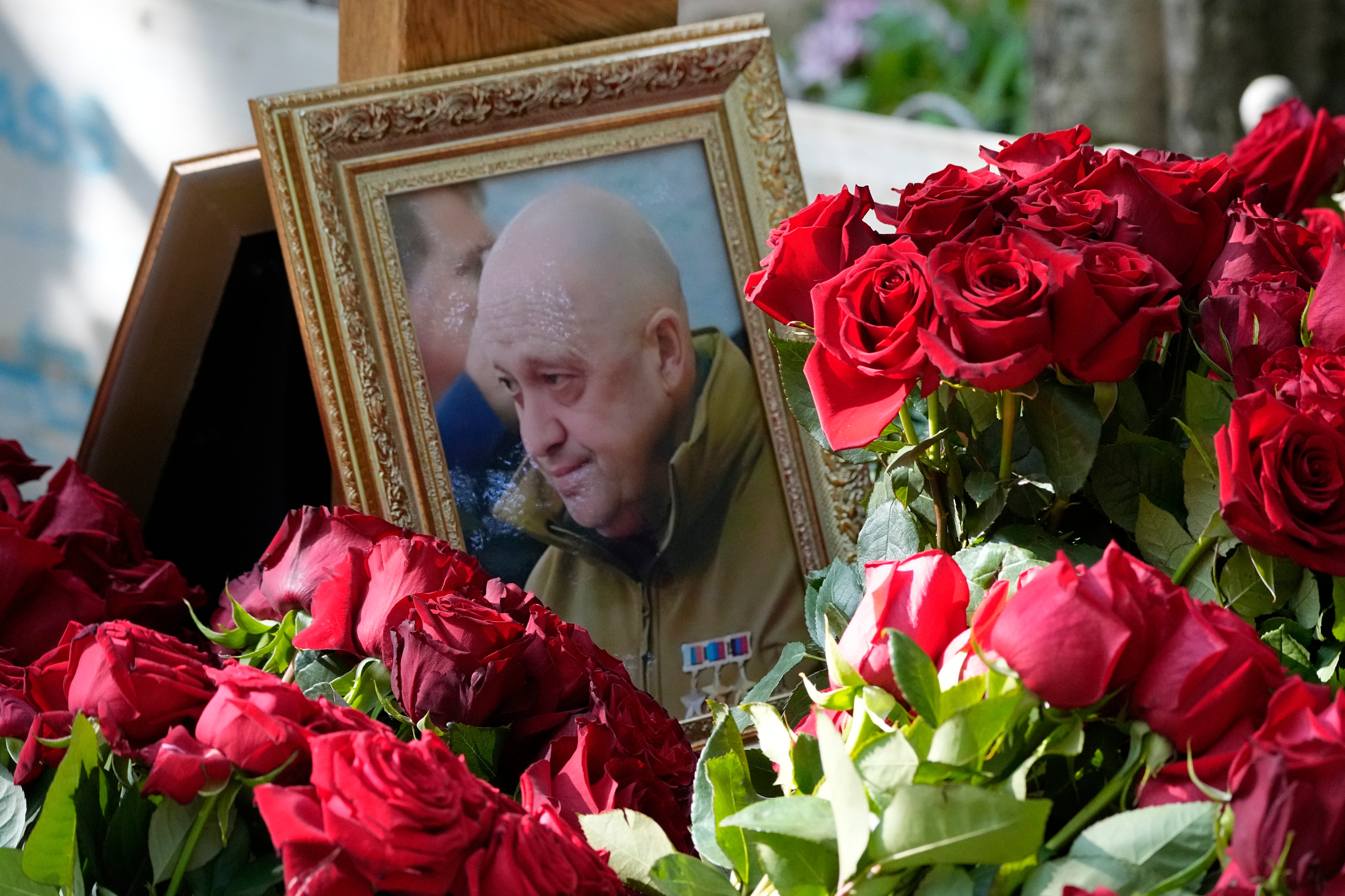 A portrait of Yevgeny Prigozhin lies on flowers on the grave at the Porokhovskoye cemetery in St. Petersburg, Russia