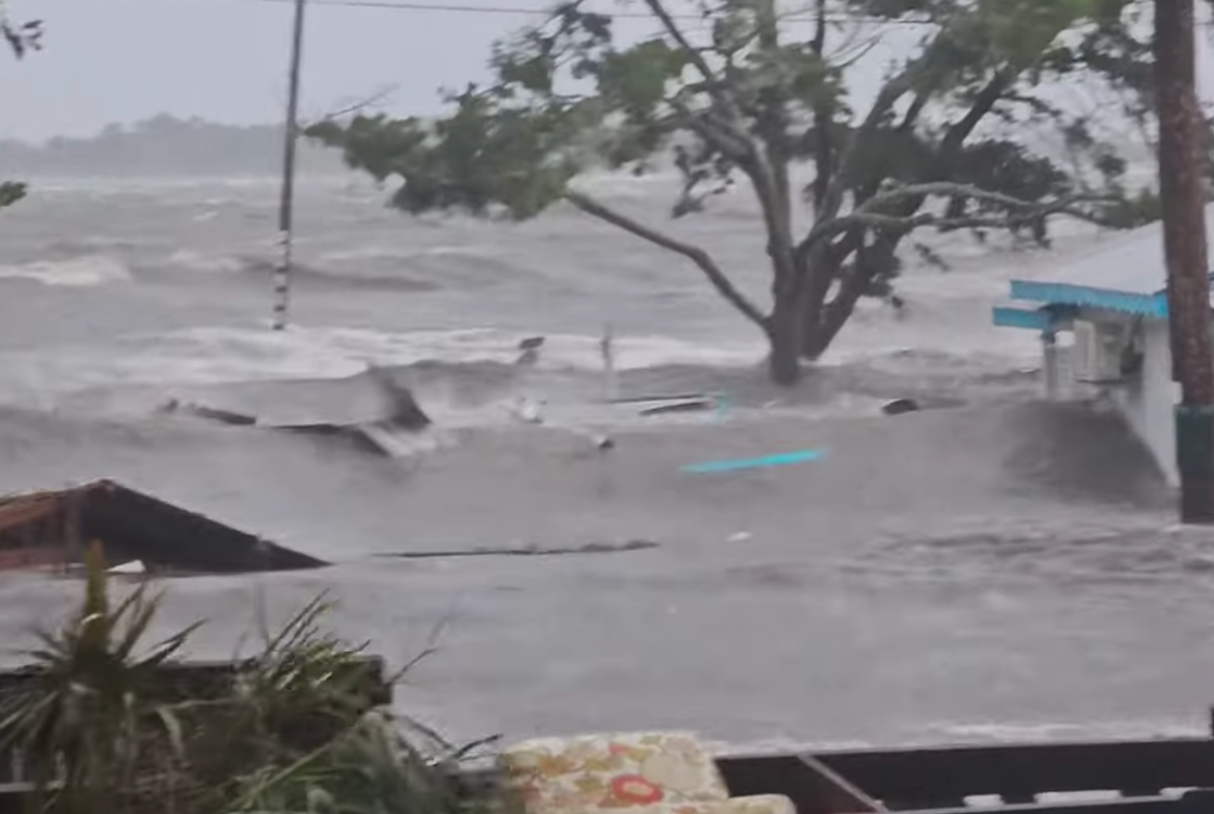 Waves were lapping up the roof lines of single story homes on Cedar Key Island after Hurricane Idalia made landfall on Wednesday with powerful winds and storm surge