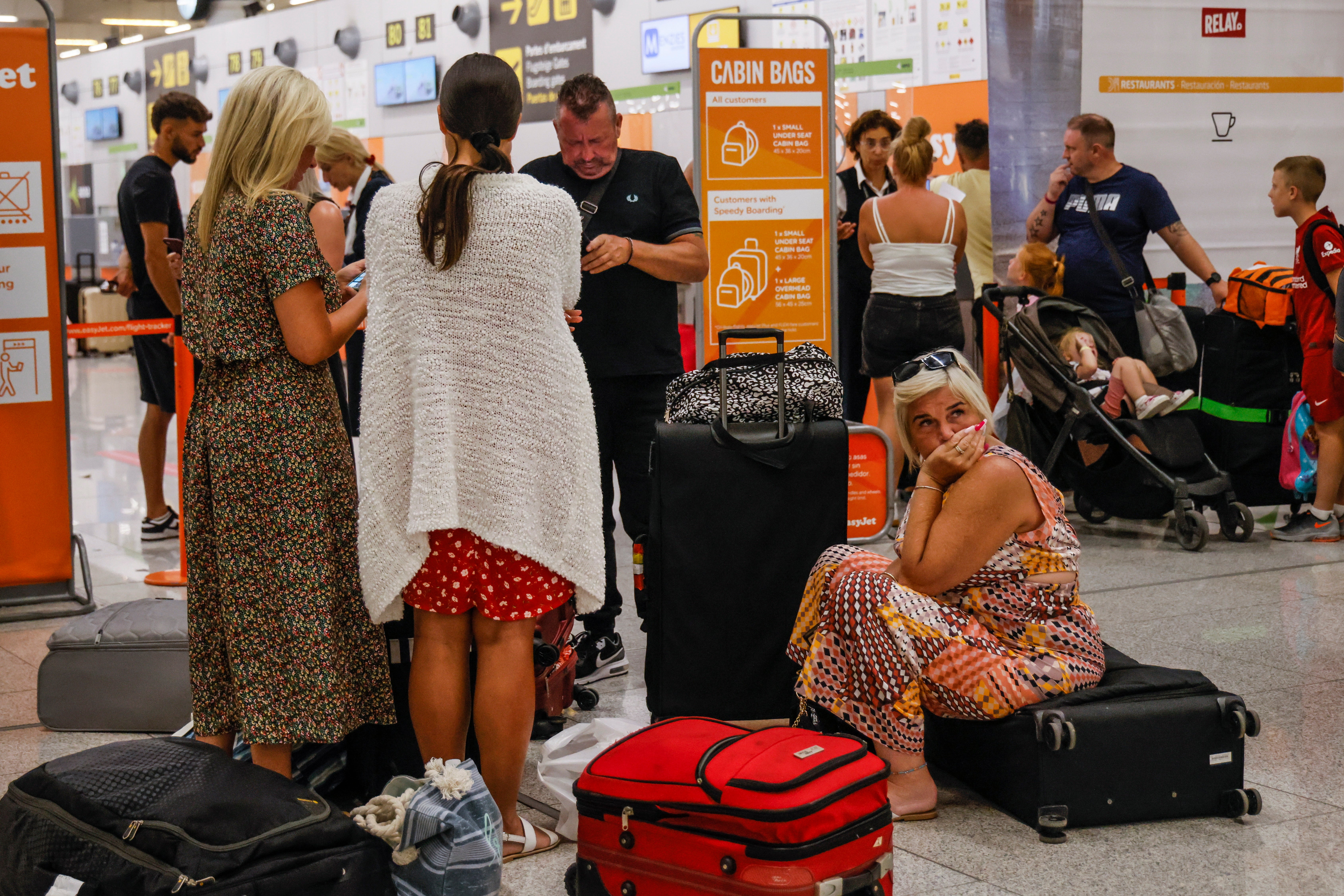 Grounded: tourists wait at the Palma de Mallorca airport for their return flight to Italy