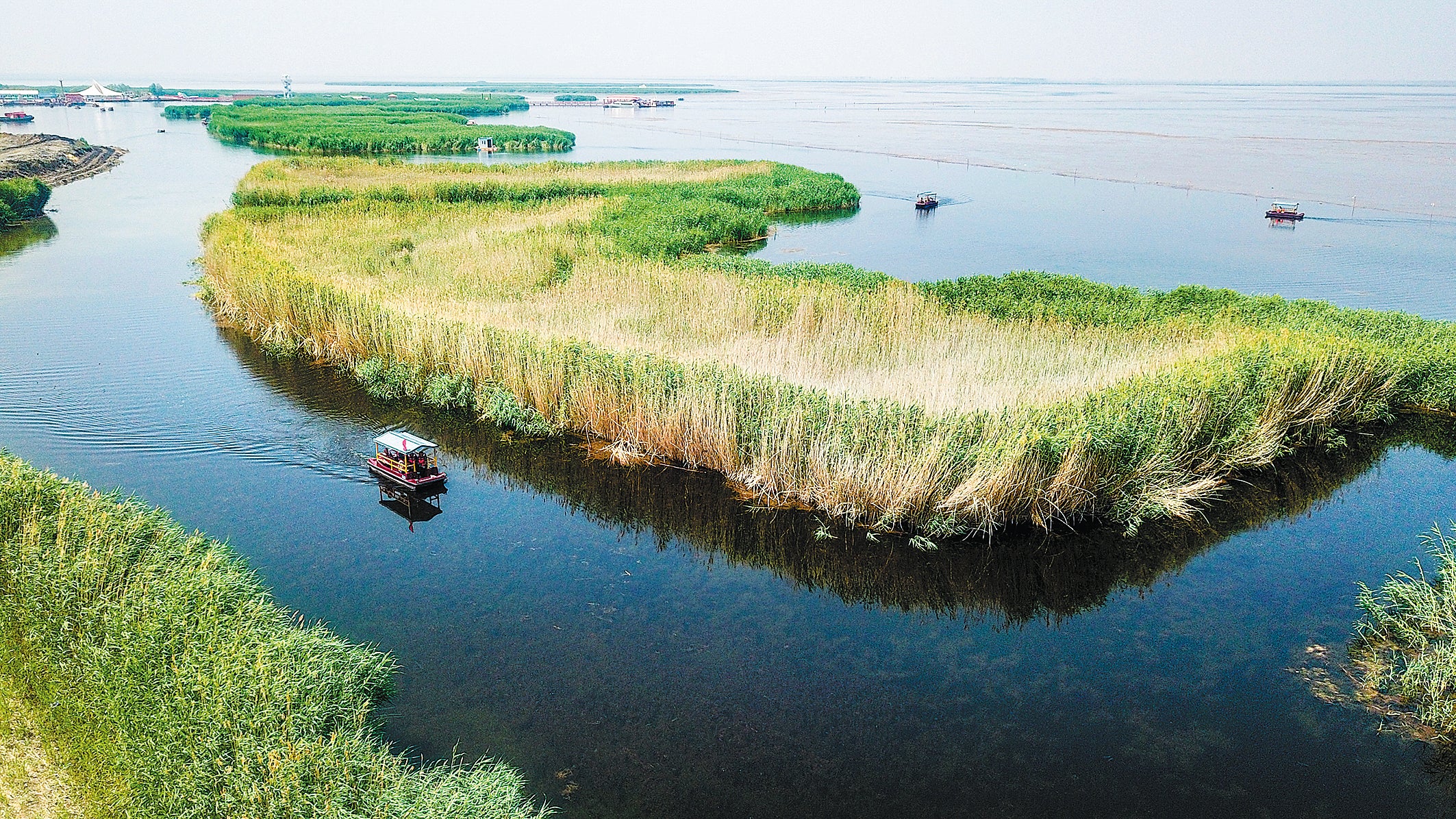 A launch takes tourists across the waters of Ulansuhai Nur on June 19, 2023