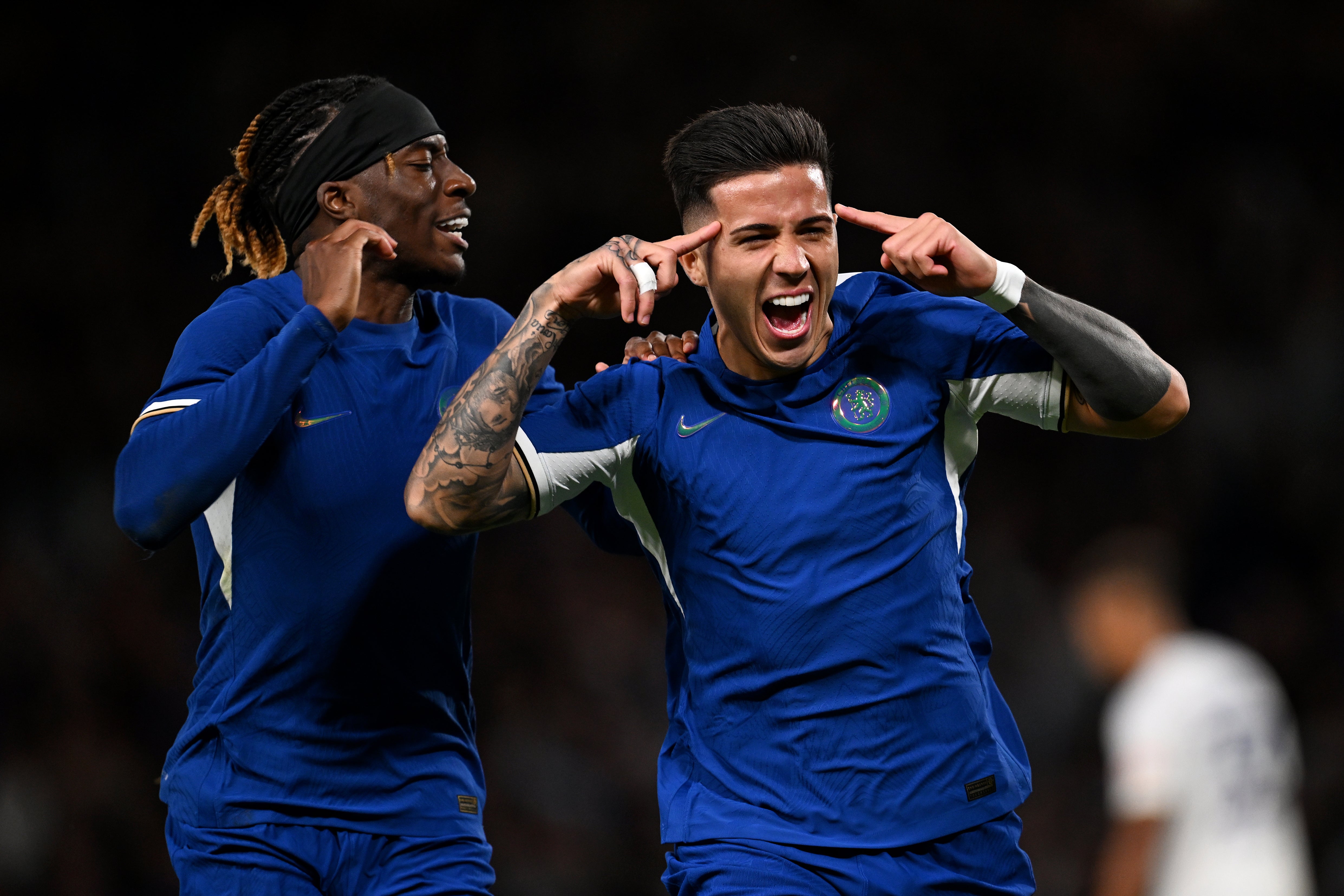 Enzo Fernandez of Chelsea (R) celebrates with teammate Noni Madueke