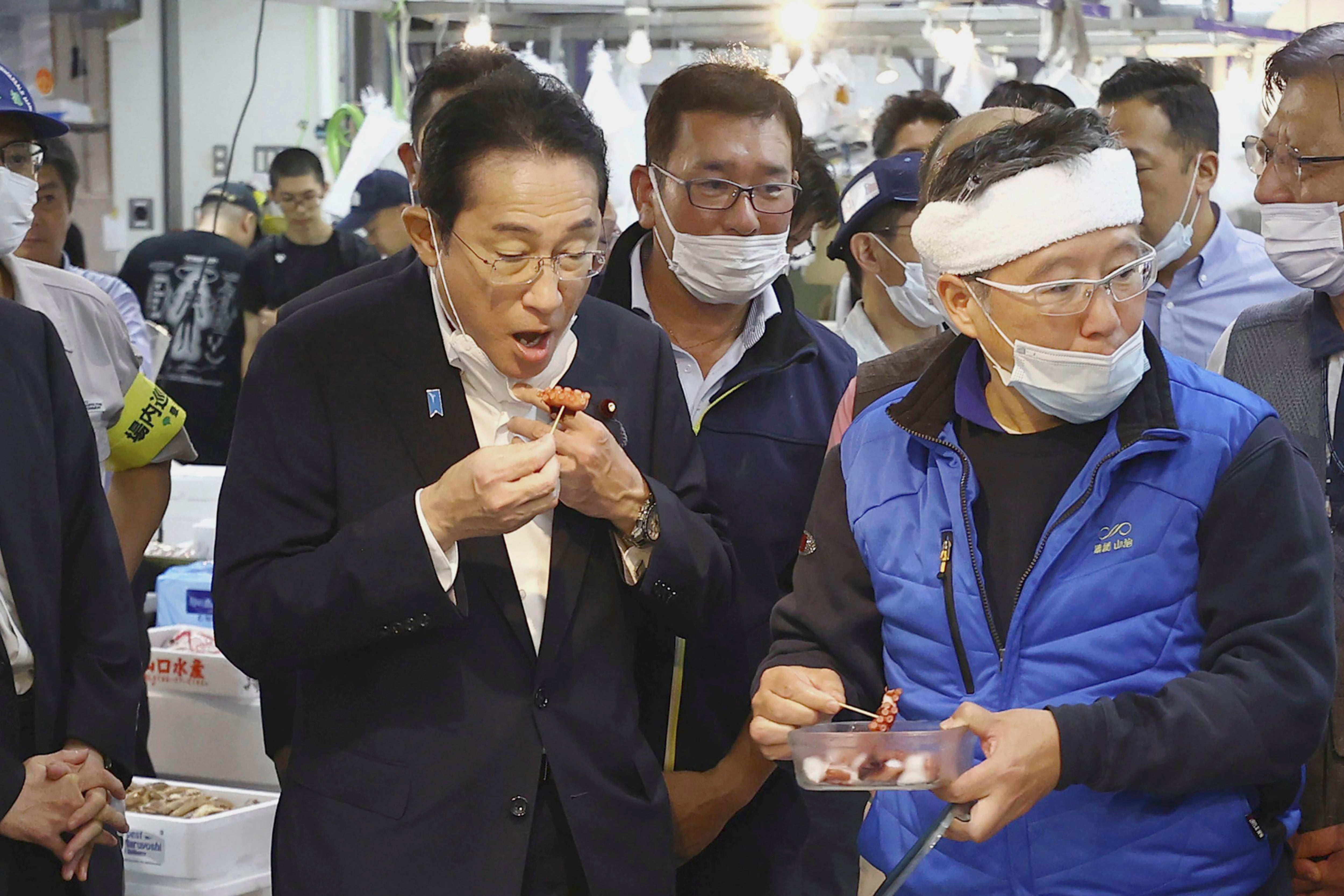 apan's Prime Minister Fumio Kishida, front left, tries a seafood at Toyosu fish market in Tokyo Thursday, 31 August 2023