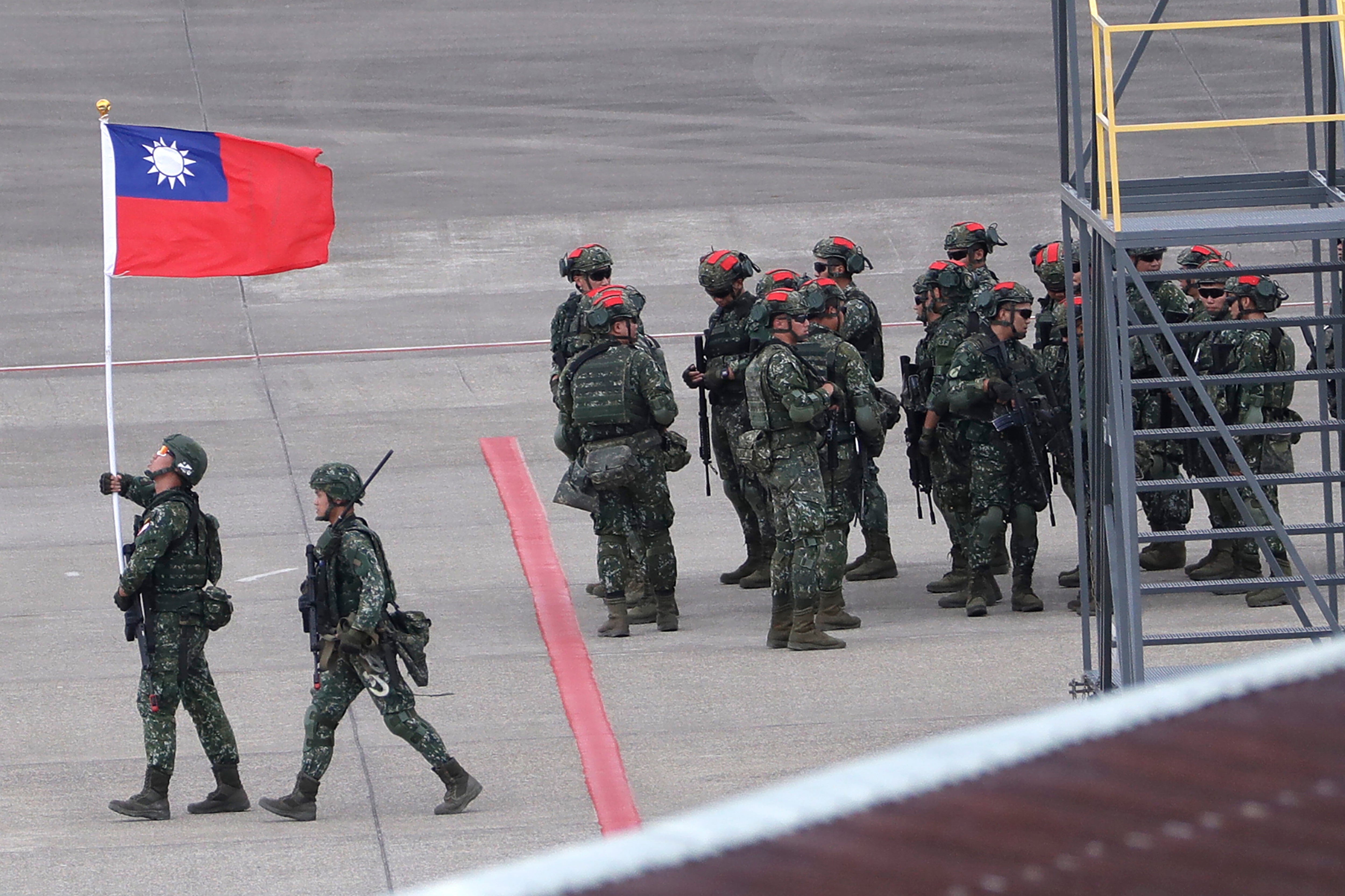 A Taiwanese soldier holds a Taiwan national flag