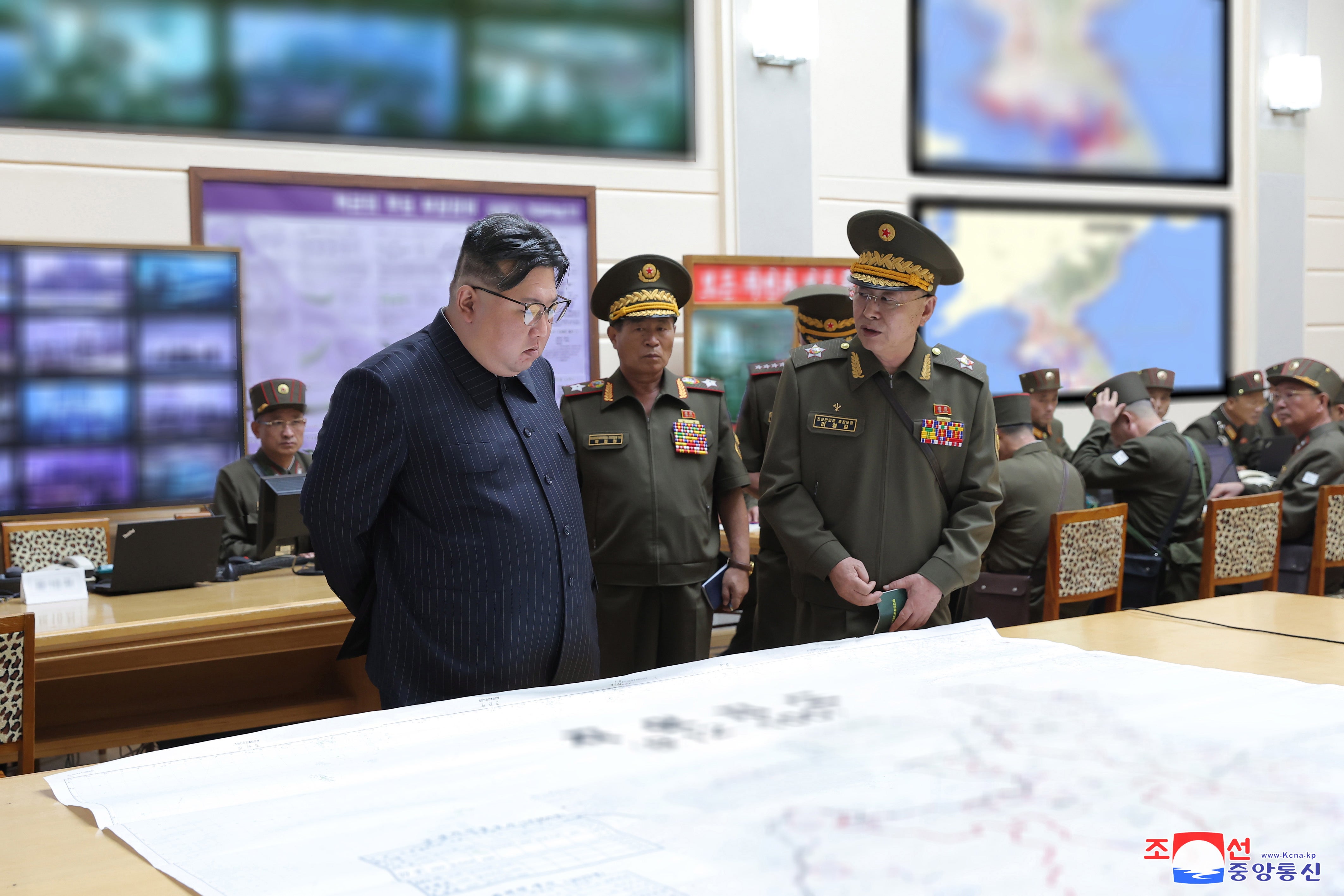 A photo released by KCNA shows Kim Jong-un (left), accompanied by Korean People’s Army Marshal Pak Jong Chon (centre) and Minister of National Defence General Kang Sun Nam (right), visiting a training command post at an undisclosed location in North Korea on 29 August