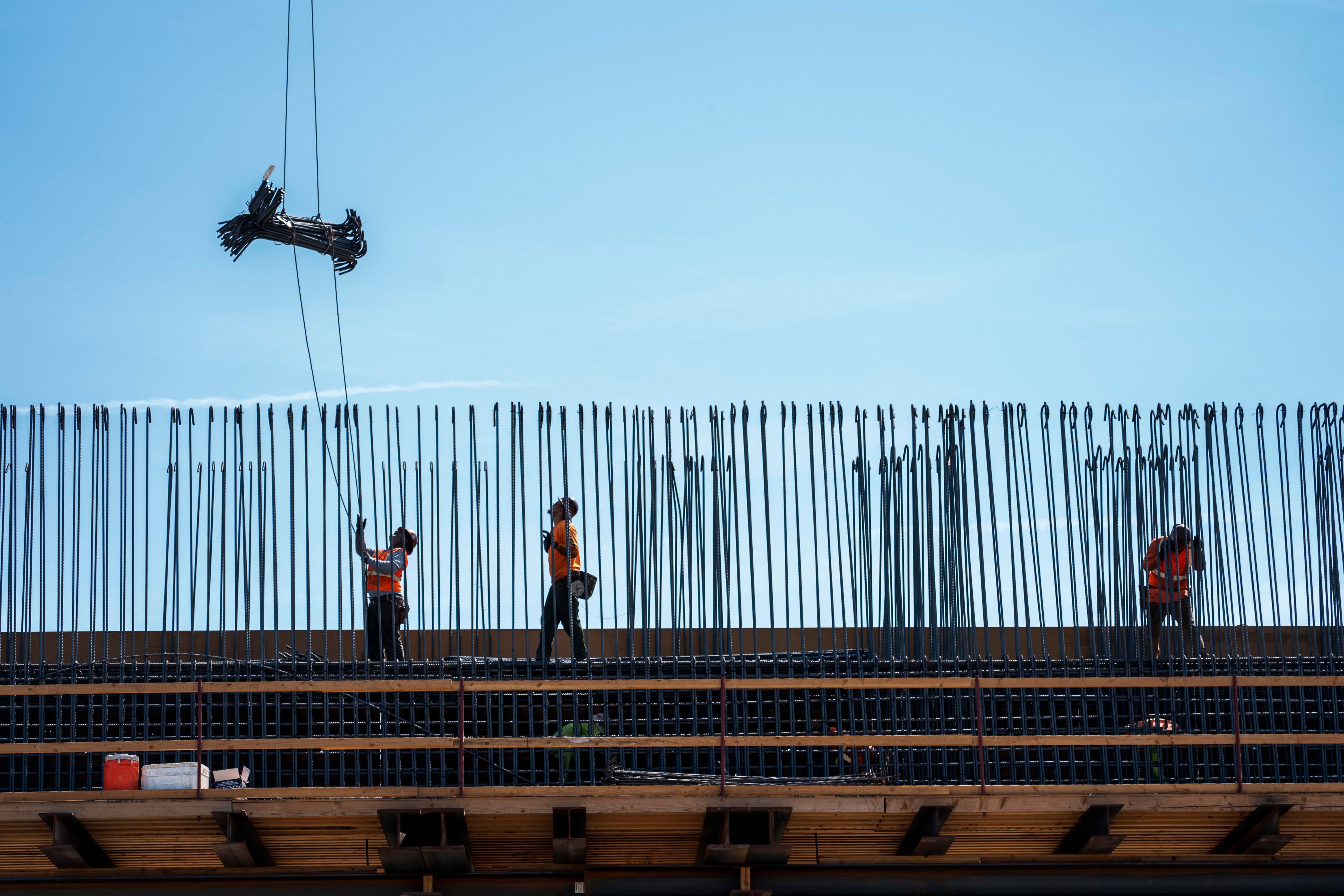 Ironworkers construct the Conejo Viaduct, a 2,000-foot viaduct that will carry high-speed trains over an existing BNSF rail line and Conejo Avenue near Fresno, California