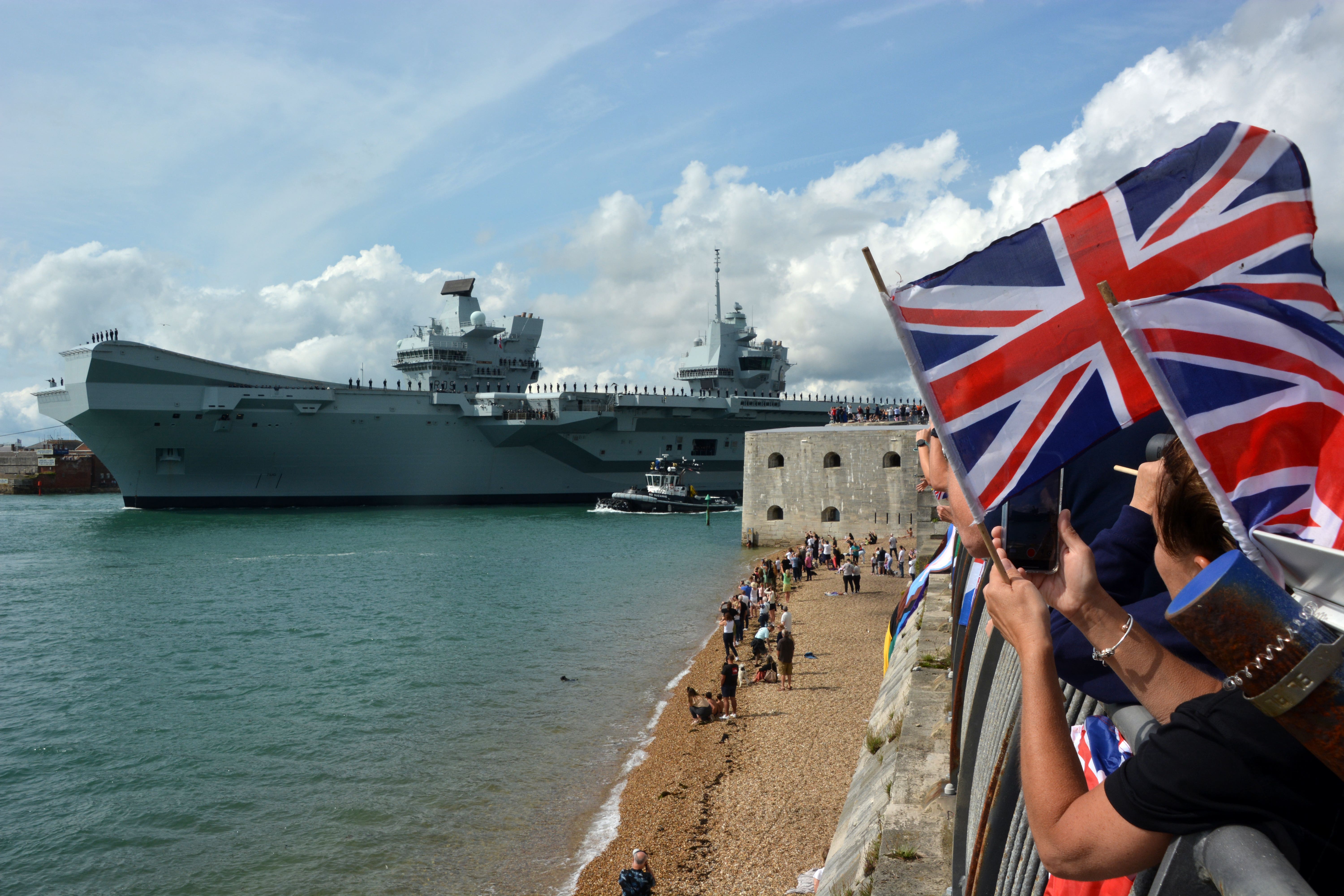 Families and well-wishers wave off Royal Navy aircraft carrier HMS Prince of Wales as it leaves Portsmouth Naval Base for exercises off the coast of the US (Ben Mitchell/PA)