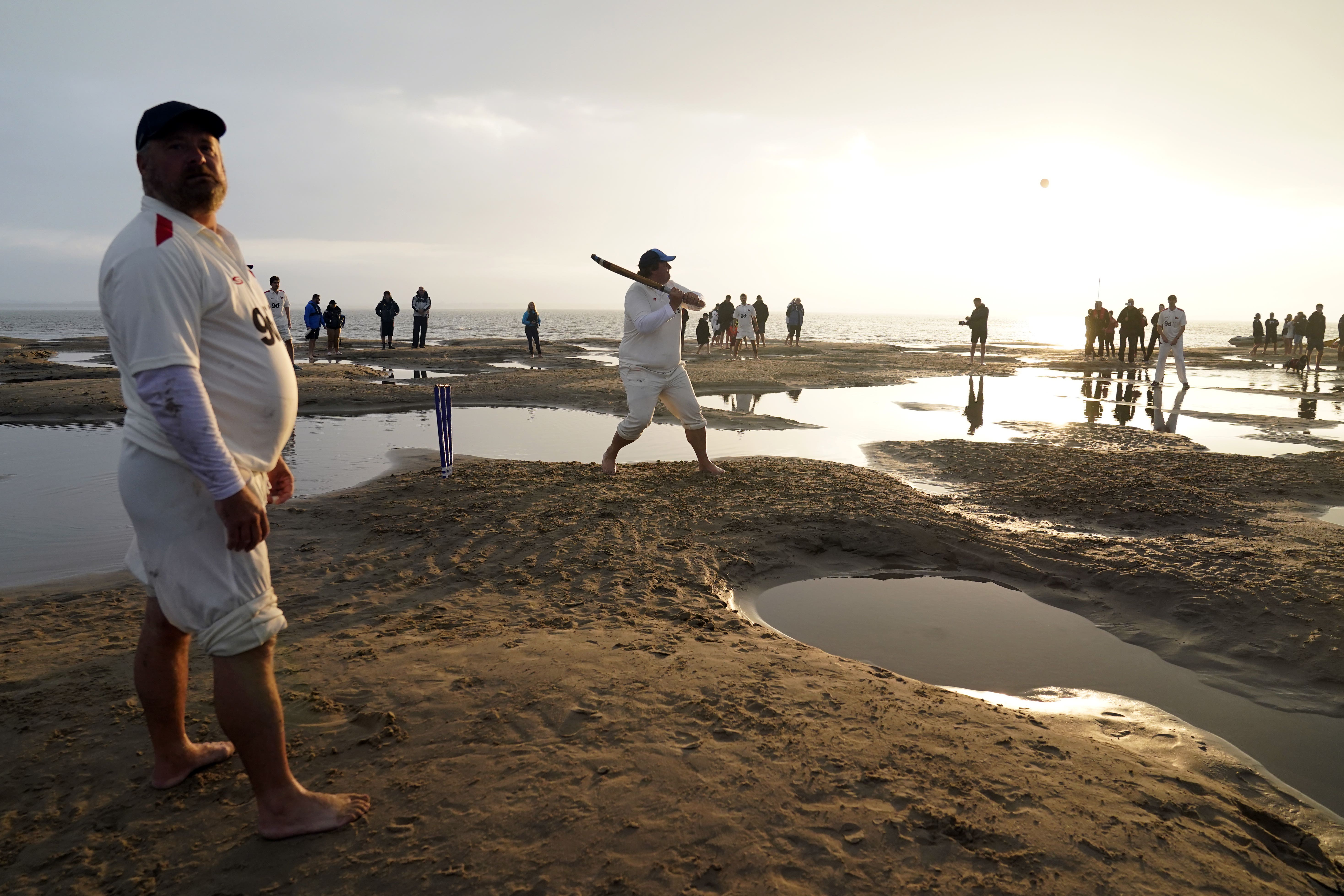 Members of the Royal Southern Yacht Club and the Island Sailing Club take part in the annual Brambles cricket match on the Bramble Bank sandbank in the middle of the Solent at low tide (Andrew Matthews/PA)