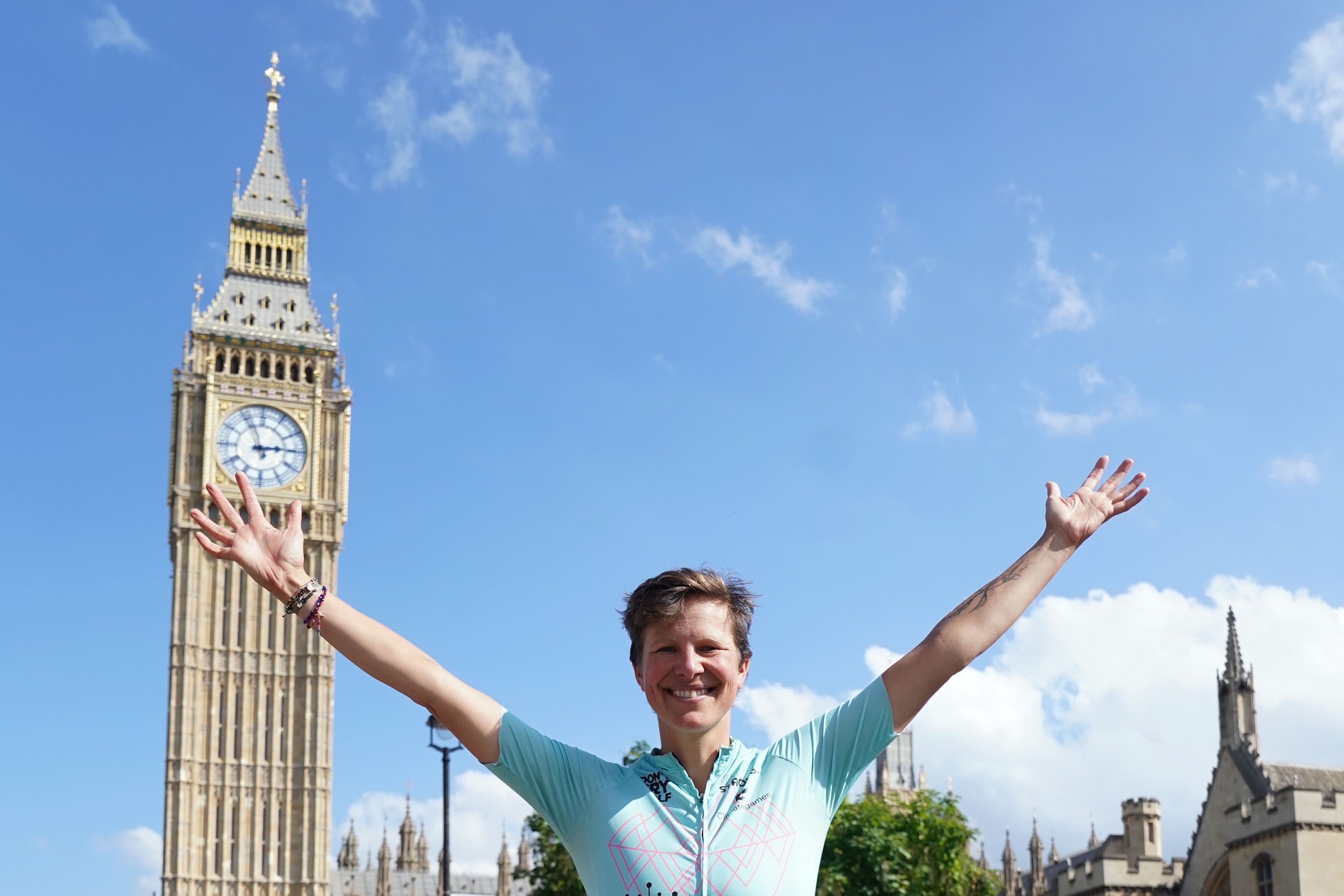 Kate Strong celebrates at Parliament Square at the finish of her challenge (Stefan Rousseau/PA)