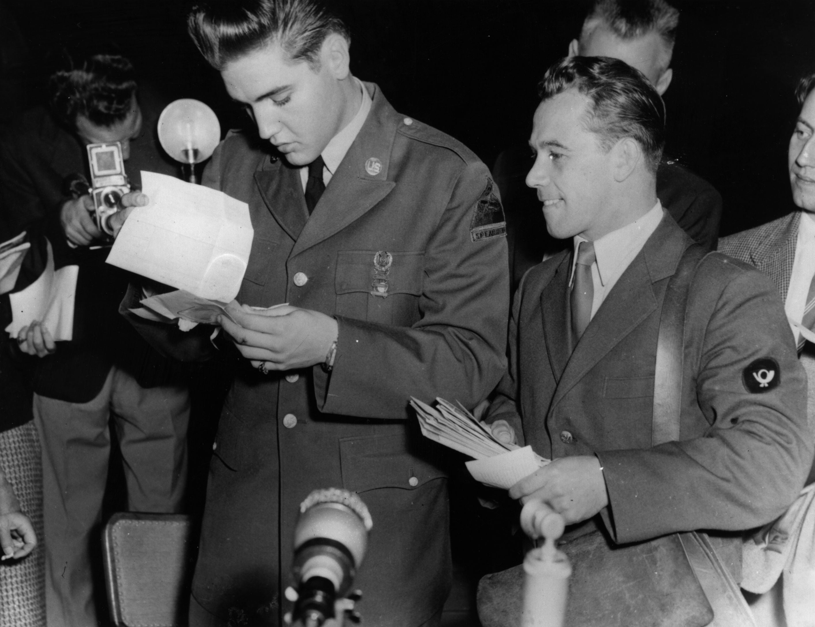 Elvis (left) pictured in Germany around the time he met Priscilla