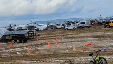 Burning Man attendees begin five mile exodus from desert site after flooded festival finishes