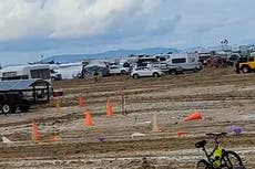 Burning Man attendees begin five mile exodus from desert site after flooded festival finishes