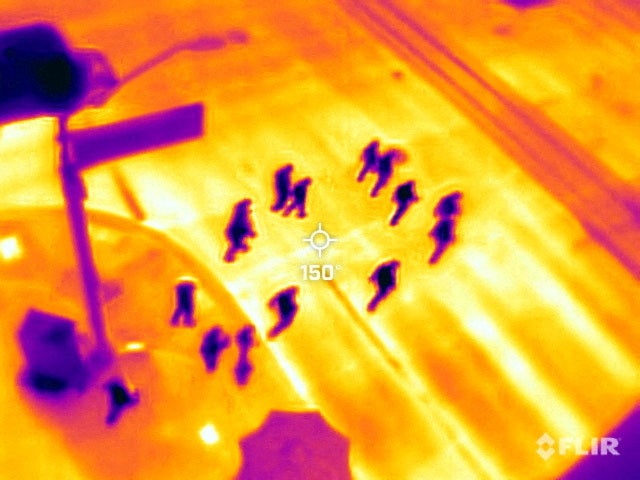 Phoenix locals cross the road to watch baseball at Chase Field during an intense heatwave on 26 July