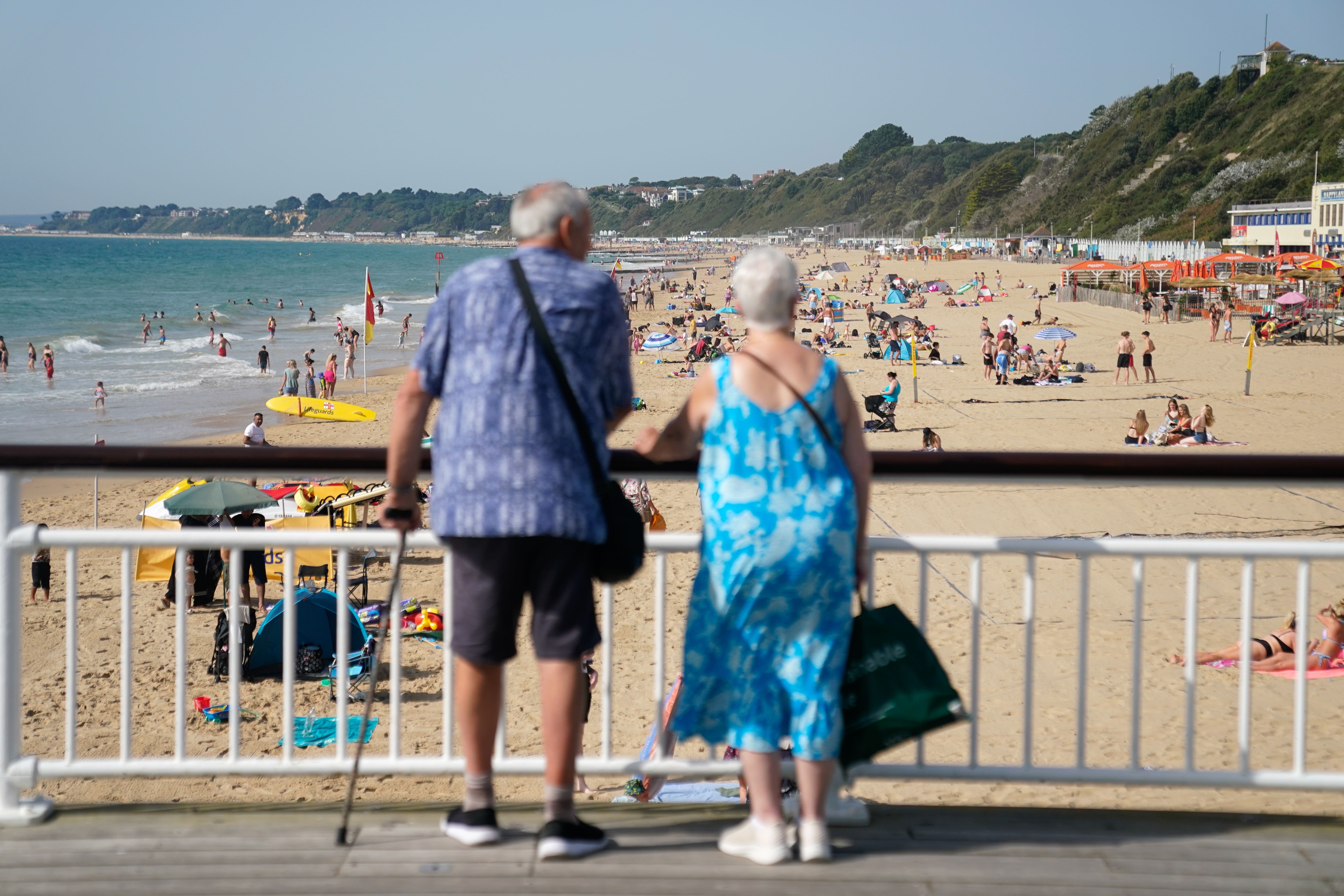 People look out from Bournemouth pier towards Bournemouth beach in Dorset (Andrew Matthews/PA)