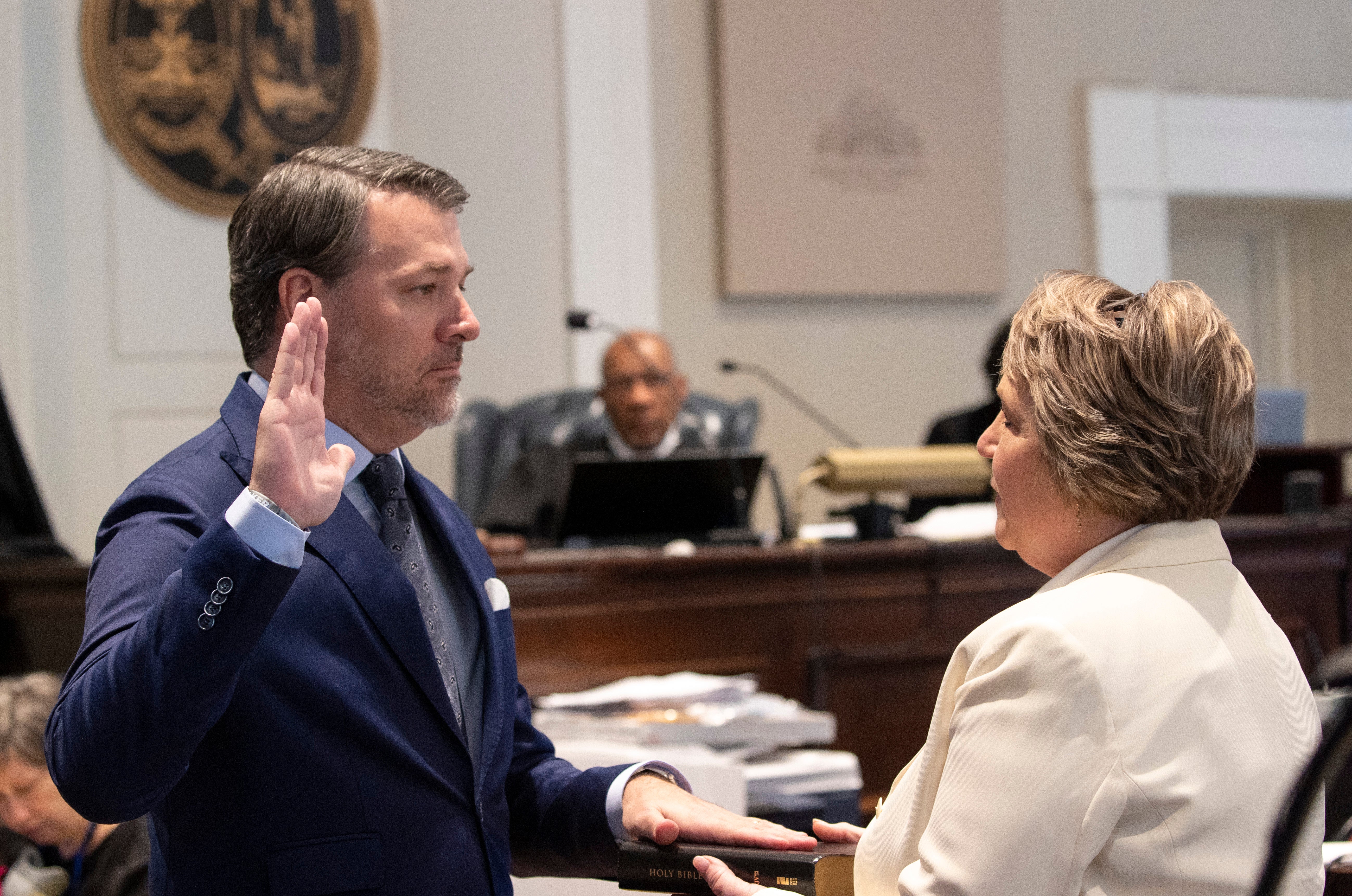 Rebecca Hill (right) swears in a witness during the trial