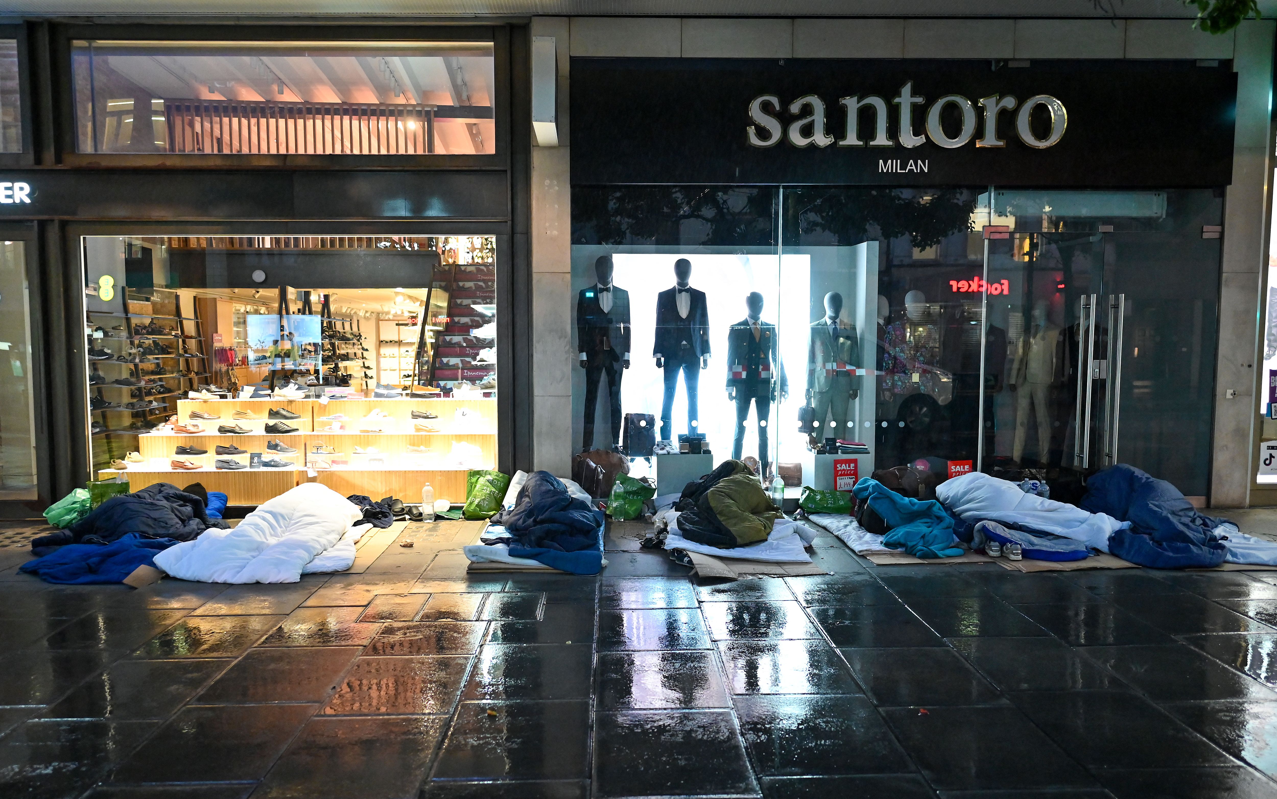 Rough sleepers lay in their makeshift beds outside closed shops on Oxford Street, in the early hours of the morning in London on August 2, 2023.