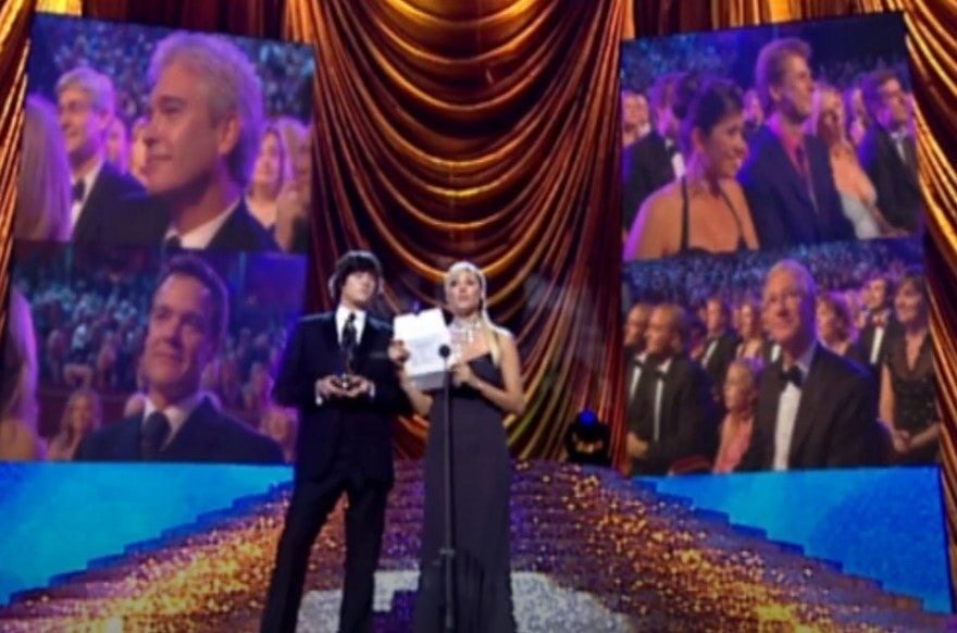 Schofield, top left, appears in footage from the crowd from a ceremony many years ago