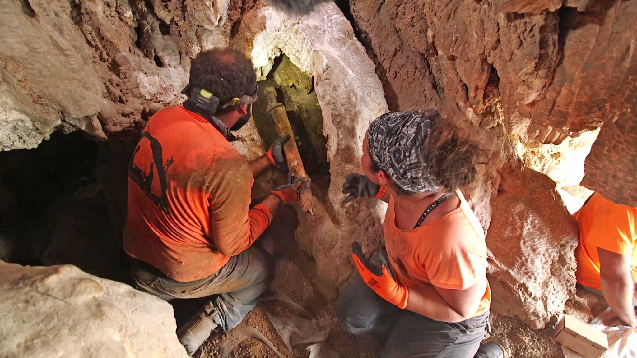 Removing the swords from the crevice where they were hidden