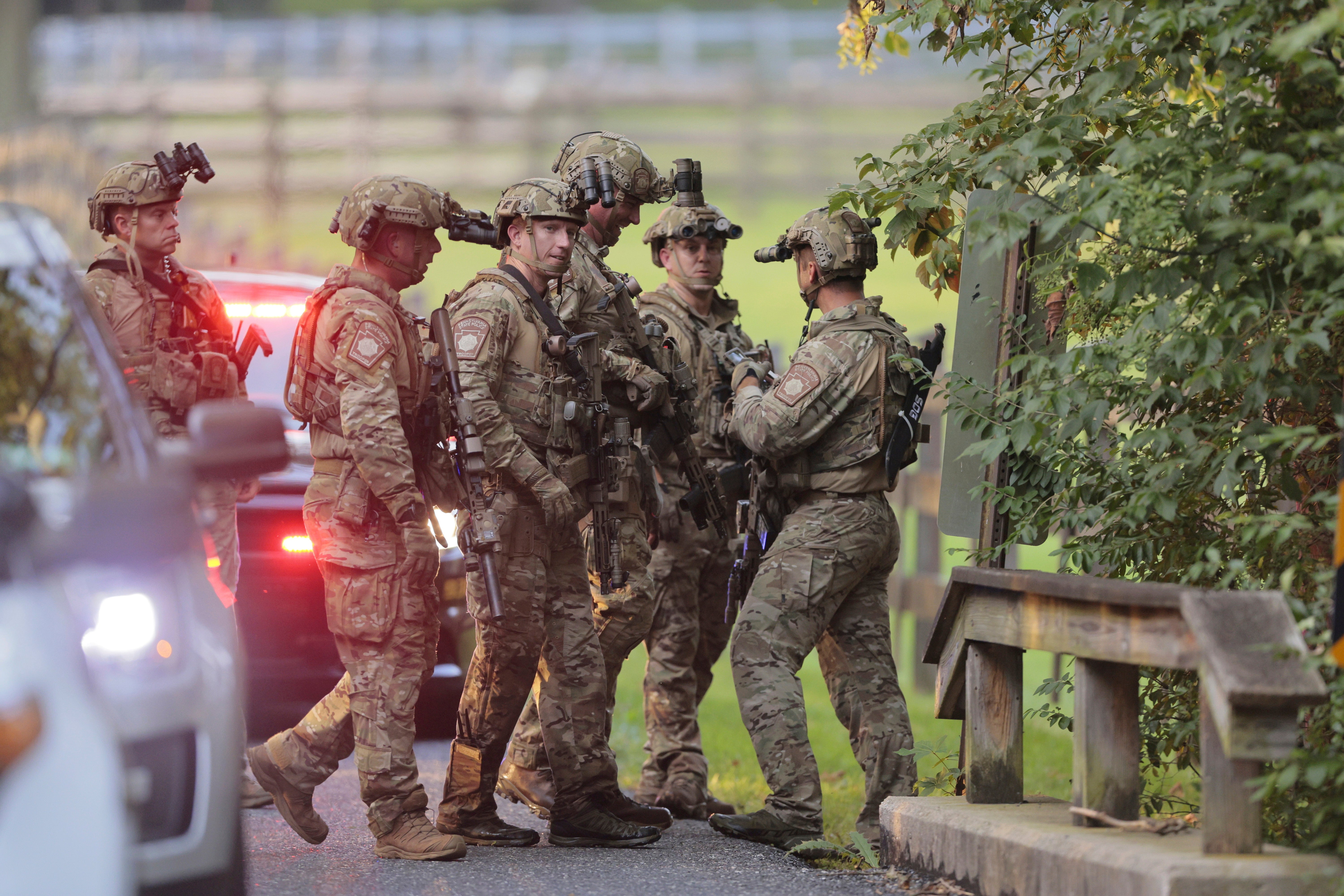 Pennsylvania State police search the woods and a creek in Pennsbury Township, Pa