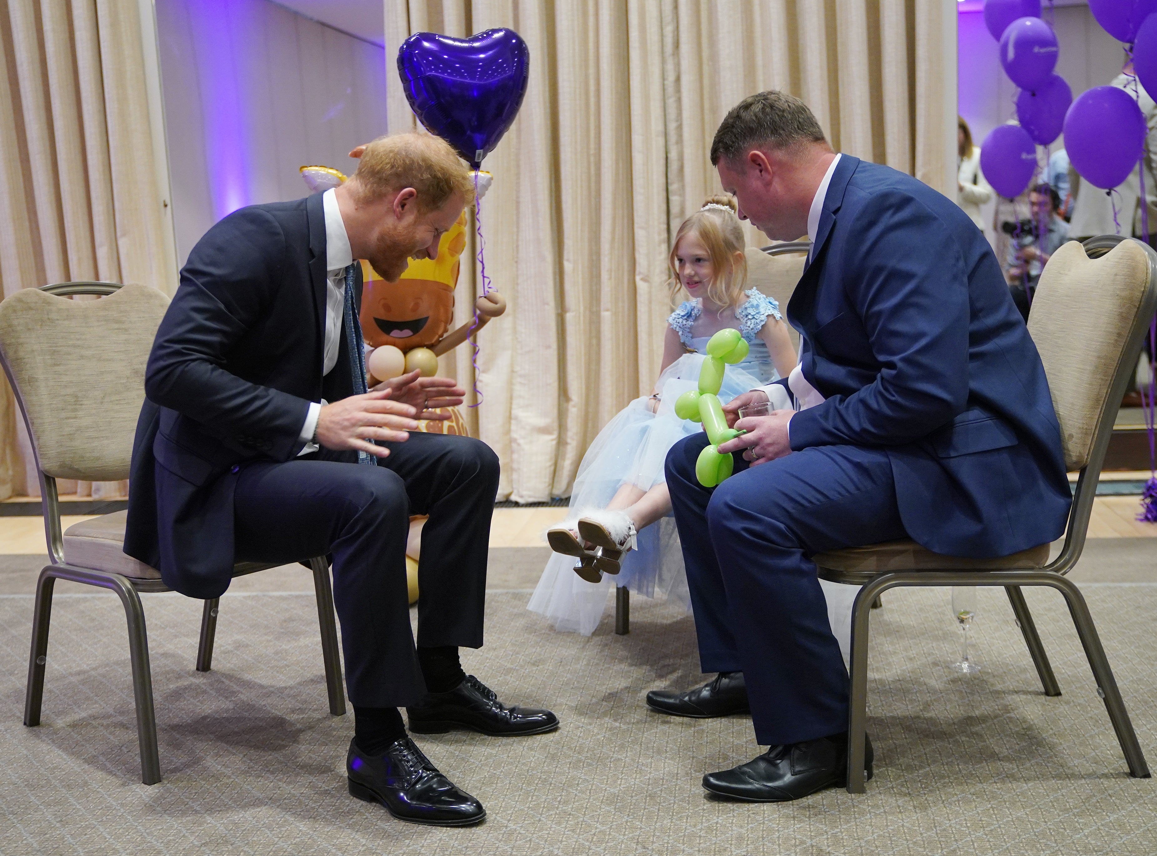 Prince Harry with Poppy and her father Daniel Higham at the WellChild Awards