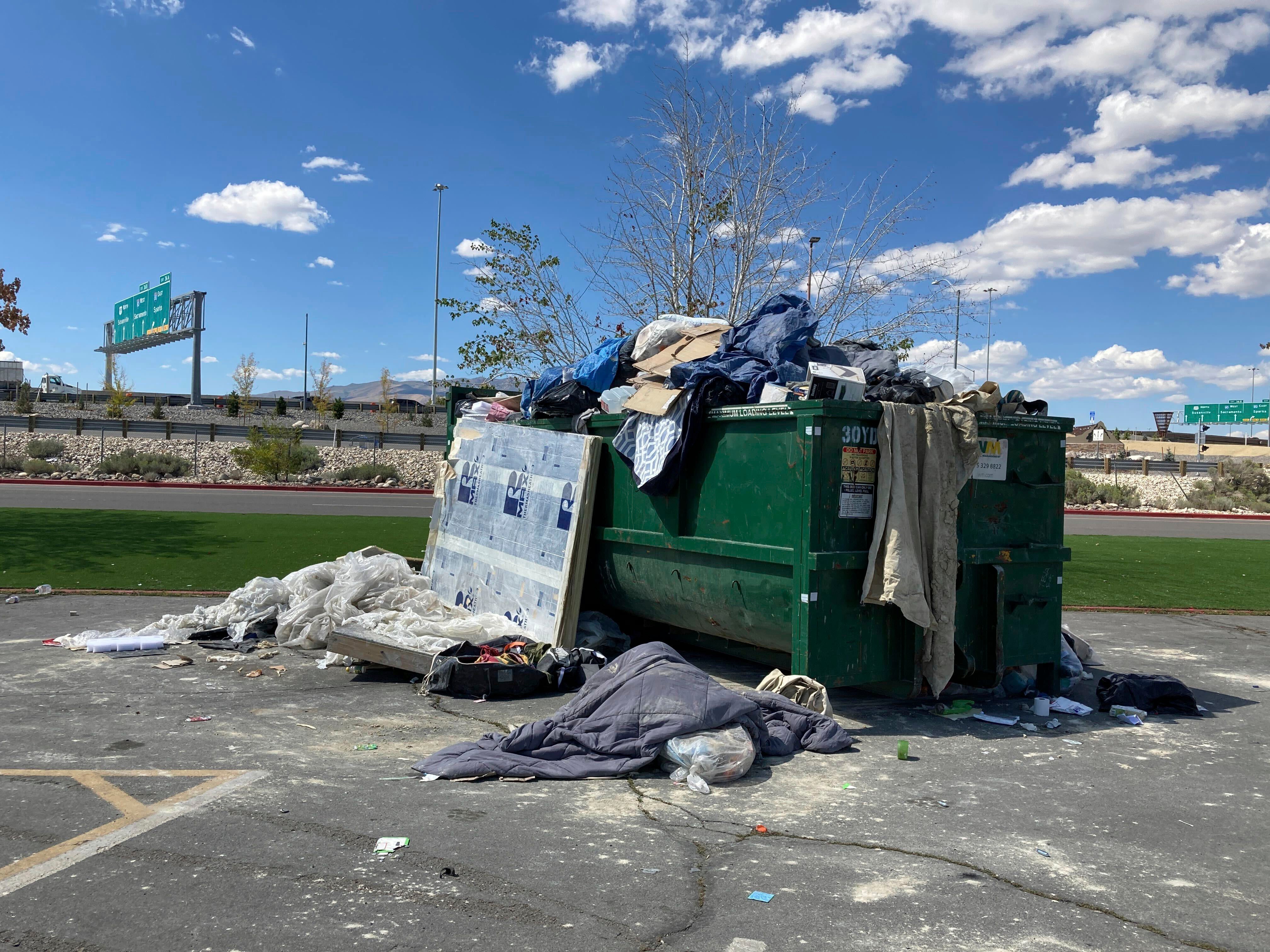 An overflowing dumpster is seen in the Grand Sierra Resort and Casino parking lot in Reno