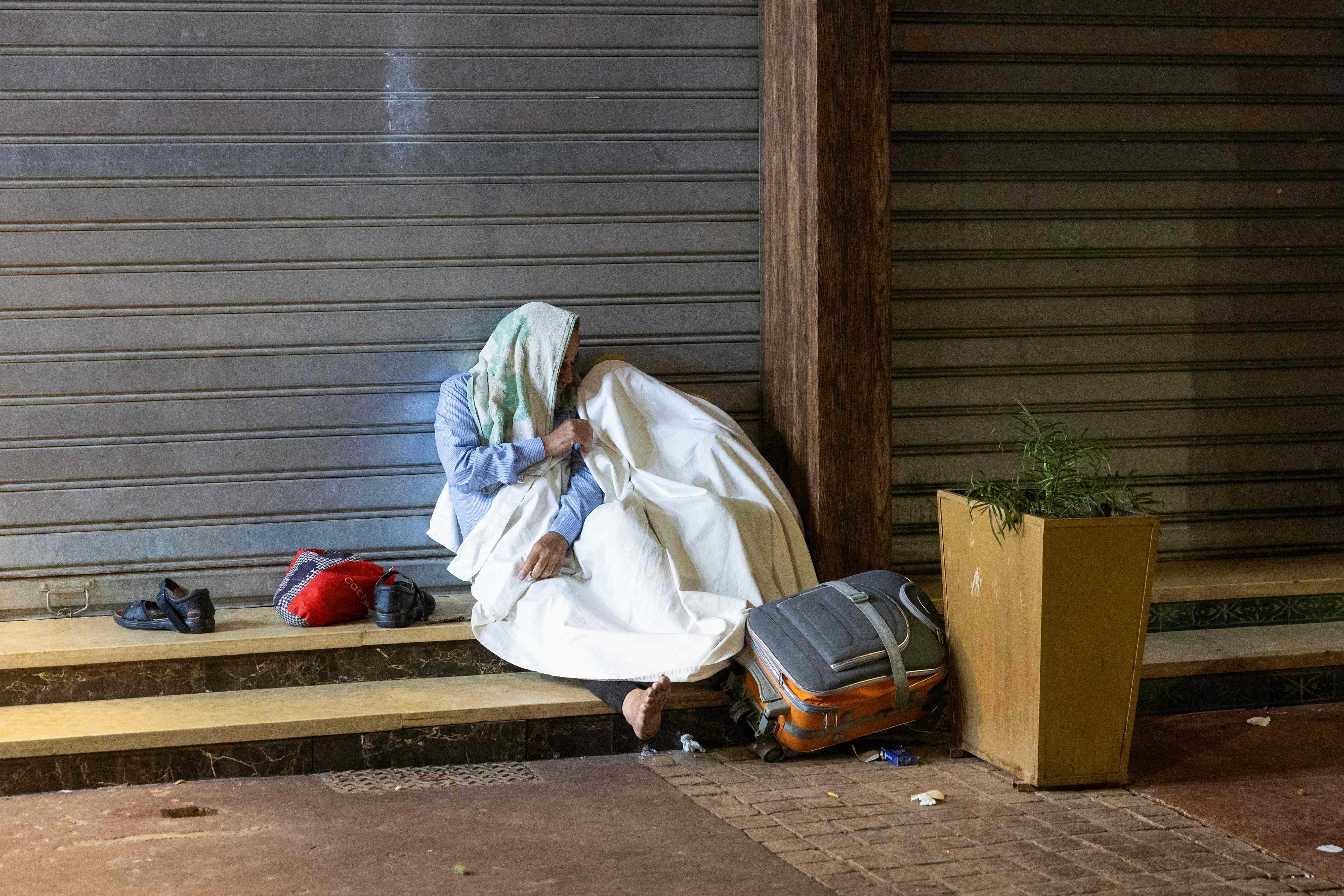 Residents take shelter outside shops in Marrakech