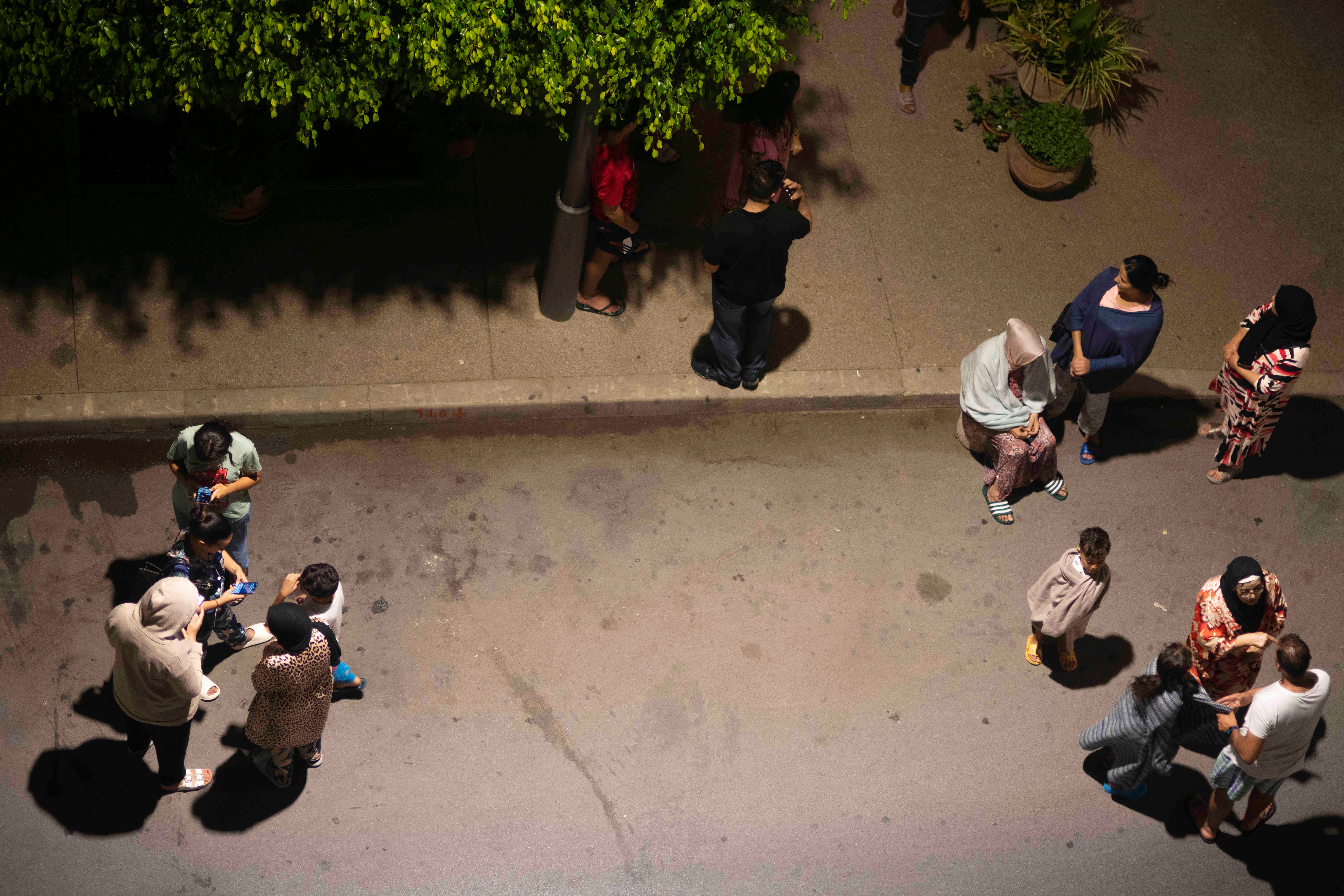 People take shelter and check for news on their mobile phones after an earthquake in Rabat (Mosa’ab Elshamy/AP/PA)