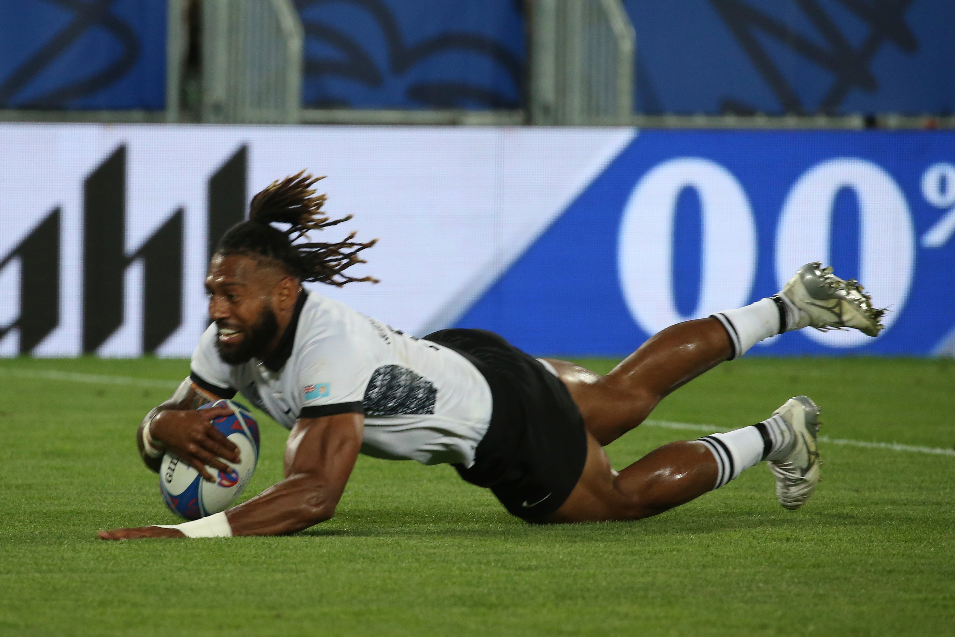 Fiji's Waisea Nayacalevu dives in to score a try