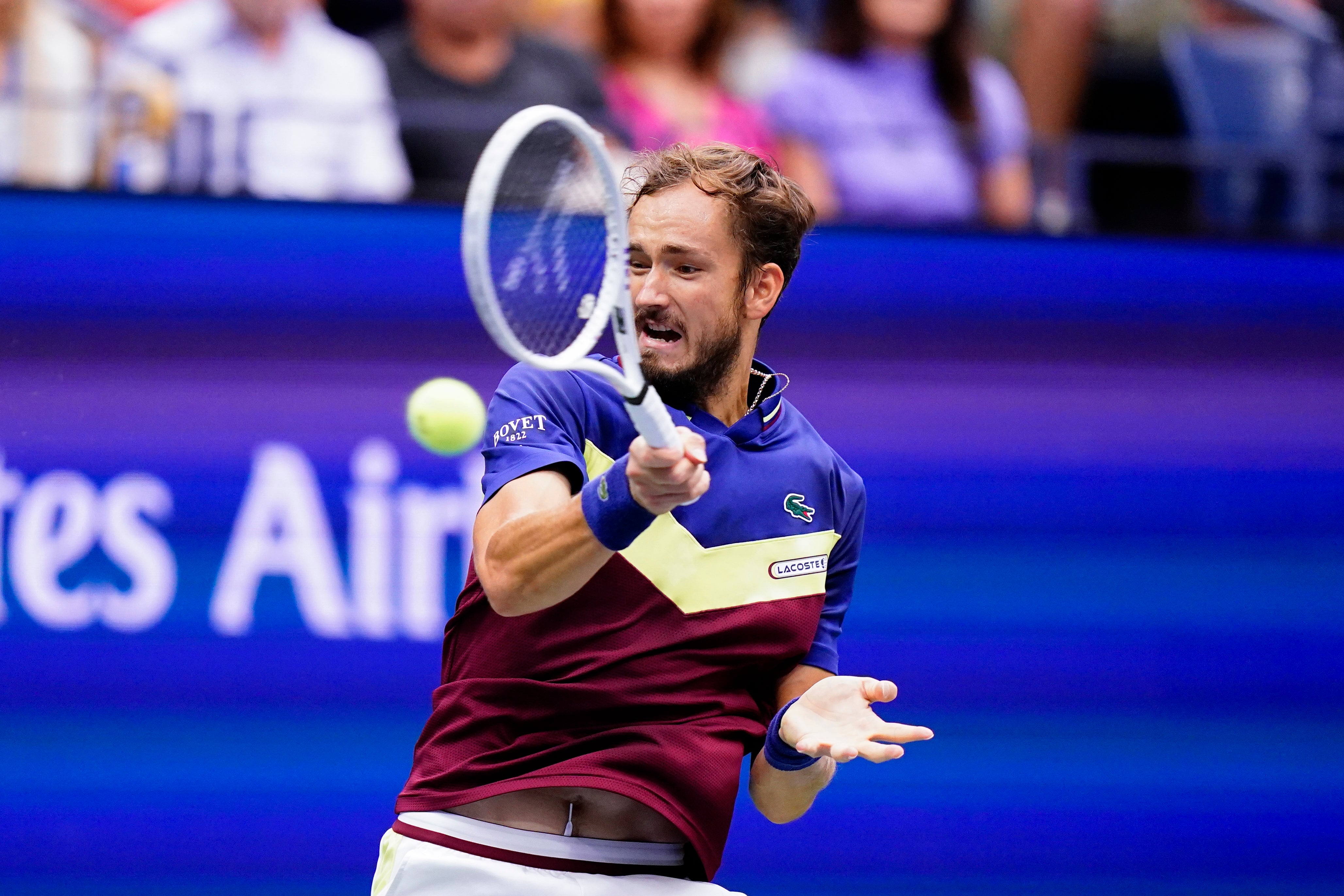 Daniil Medvedev returns a shot to Novak Djokovic