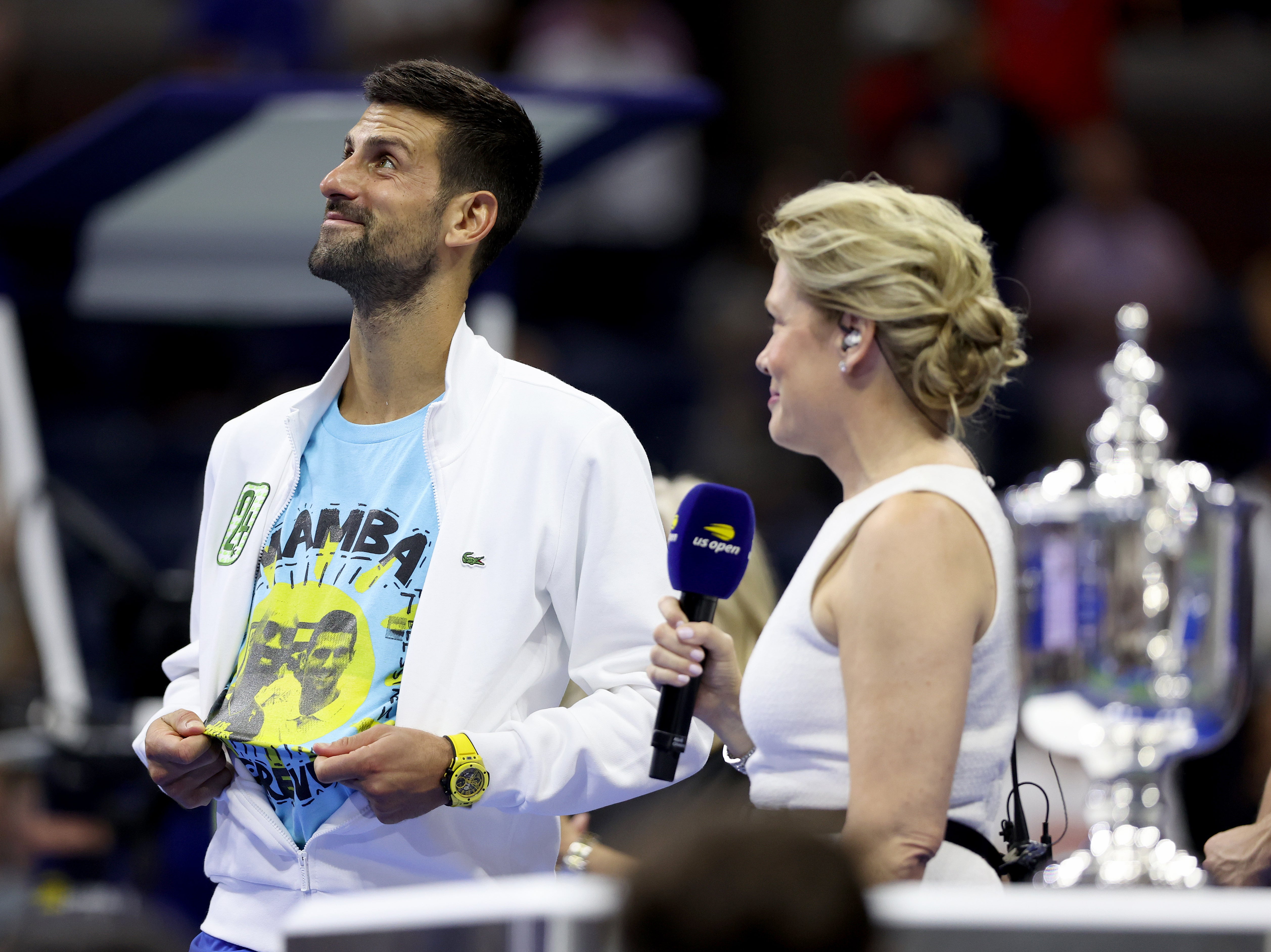 Novak Djokovic celebrates while wearing a shirt with an image of Kobe Bryant