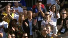 Prince Harry cheers as he watches track and field finals at the Invictus Games