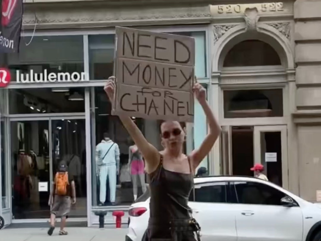 Karolina Getis holds up a ‘need money for Chanel’ sign on the streets of NYC in one of her fun TikToks.