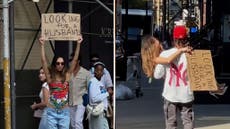 Woman sick of dating apps uses cardboard sign to look for love