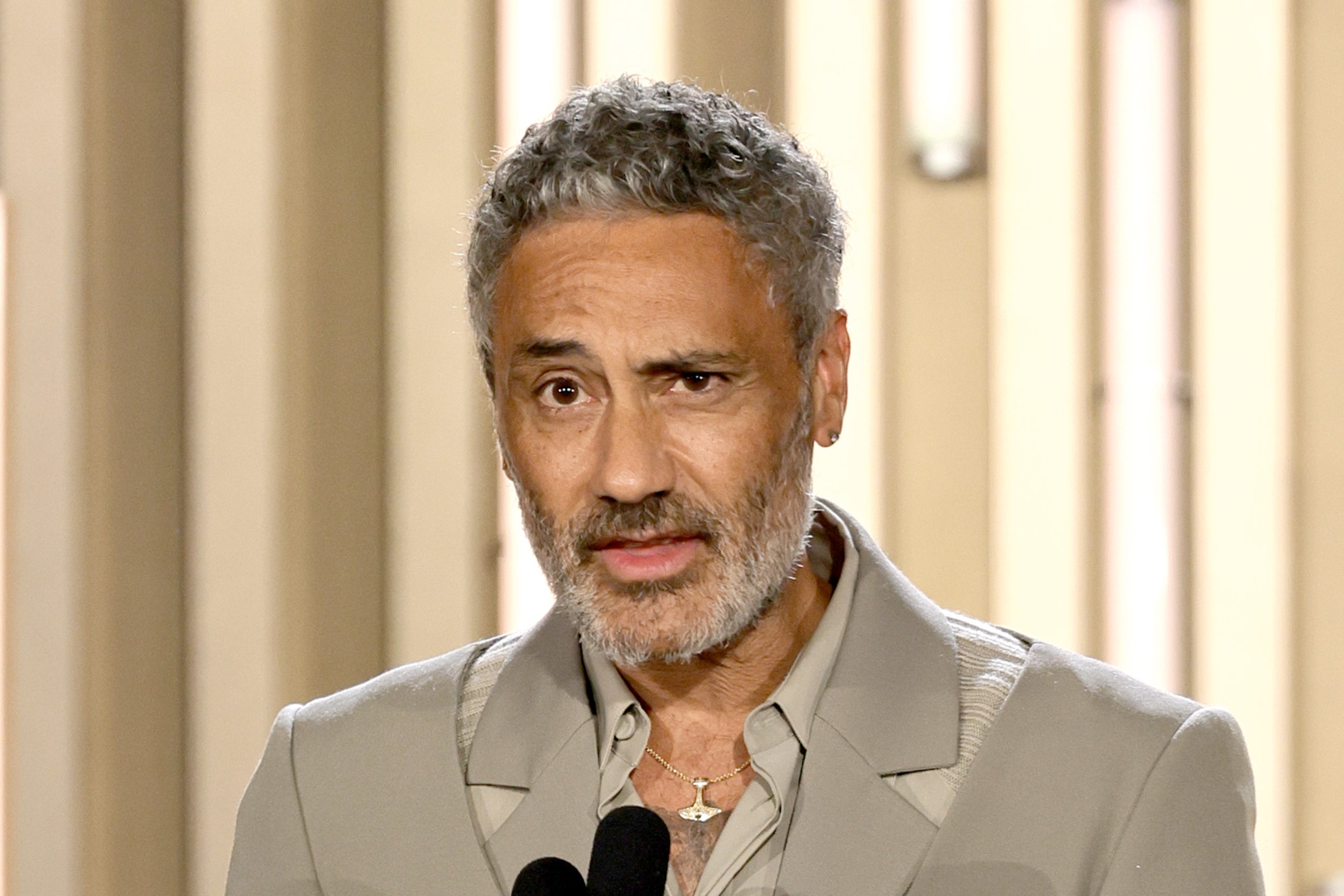 Taika Waititi speaking onstage at the Toronto International Film Festival