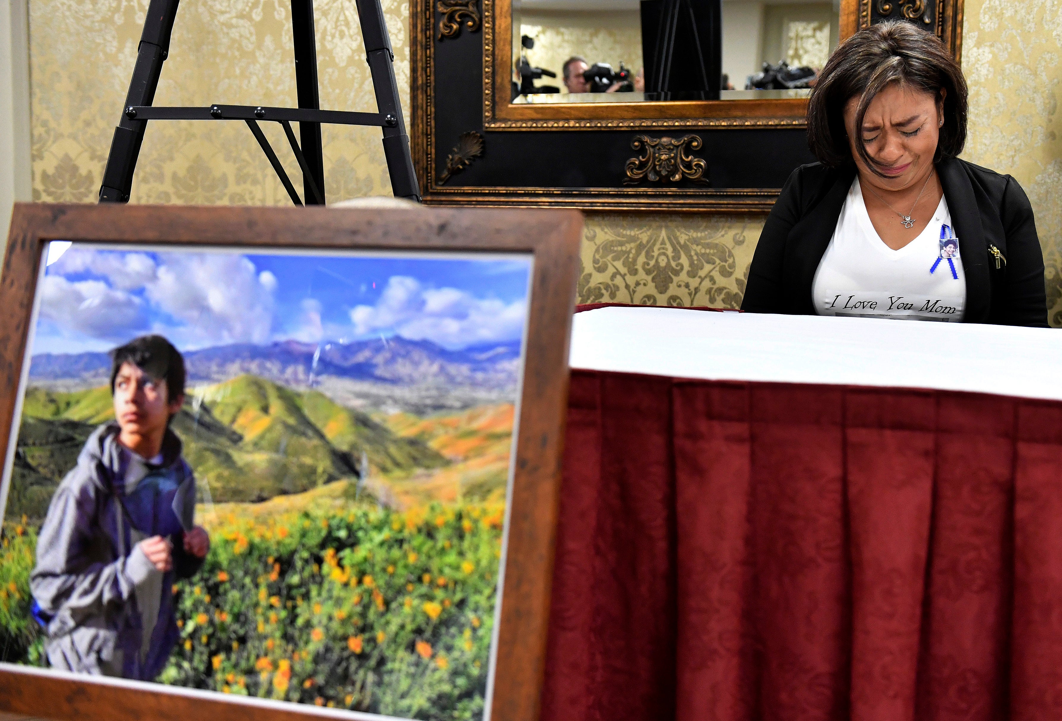 Juana Salcedo, aunt and guardian of 13-year-old Diego Stolz, cries during a news conference