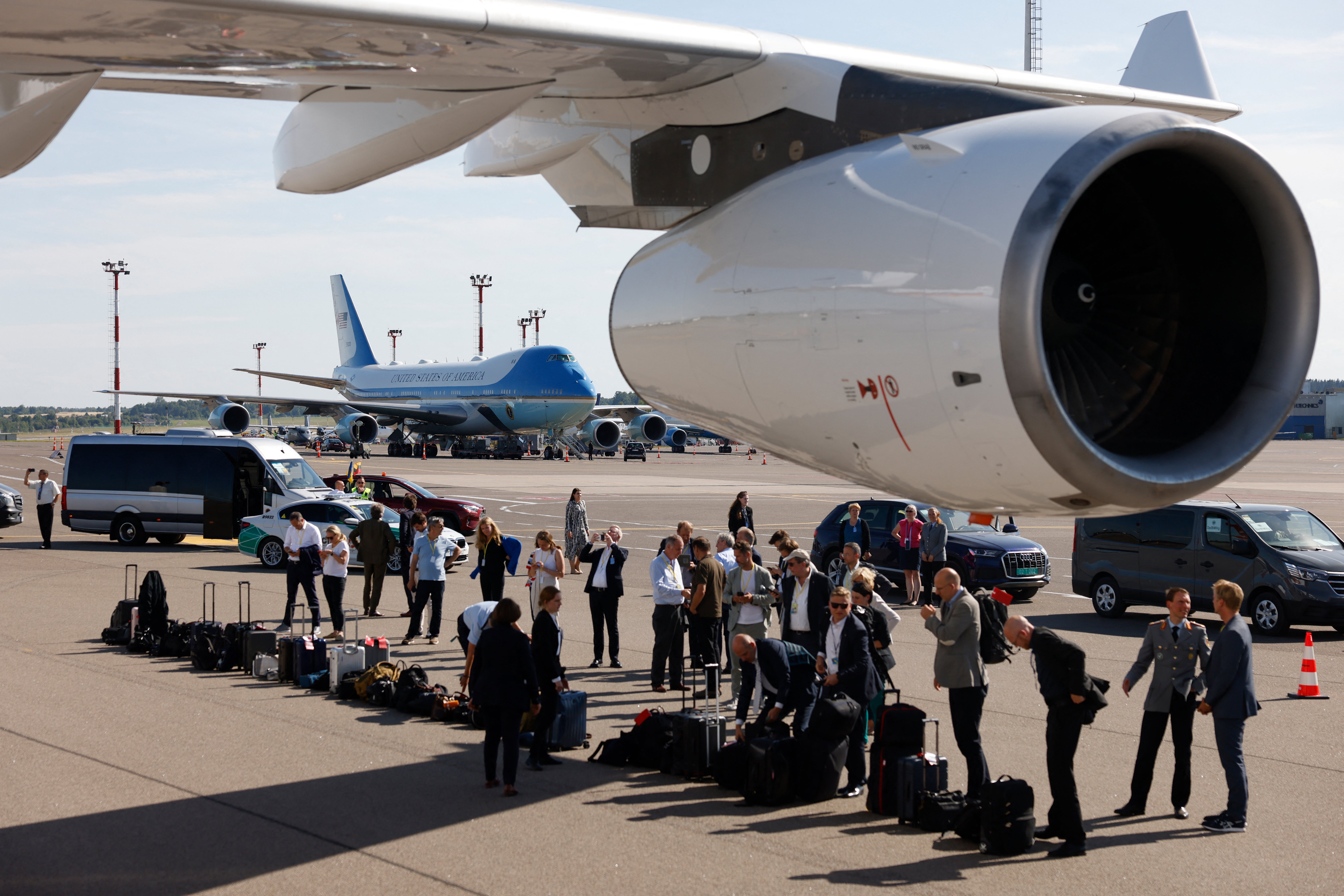 The luggage of the German delegation is lined up to be checked by sniffer dogs of the German Police assigned as security to German Chancellor Olaf Scholz’ plane before bording the flight back to Berlin with Joe Biden’s plane Air Force One in the background, from the Nato Summit in Vilnius