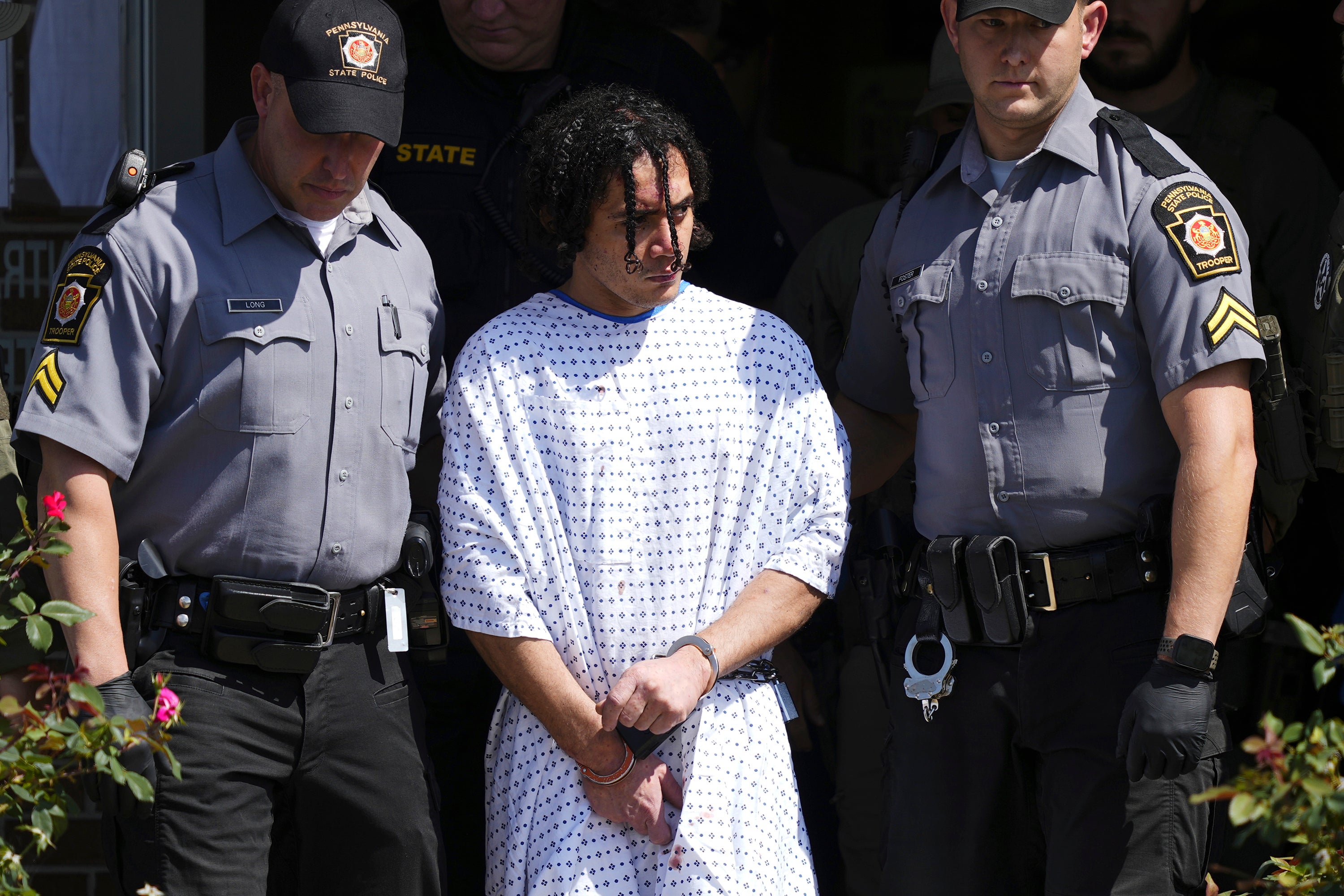 Law enforcement officers escort Danelo Cavalcante from a Pennsylvania State Police barracks in Avondale Pa., on Wednesday