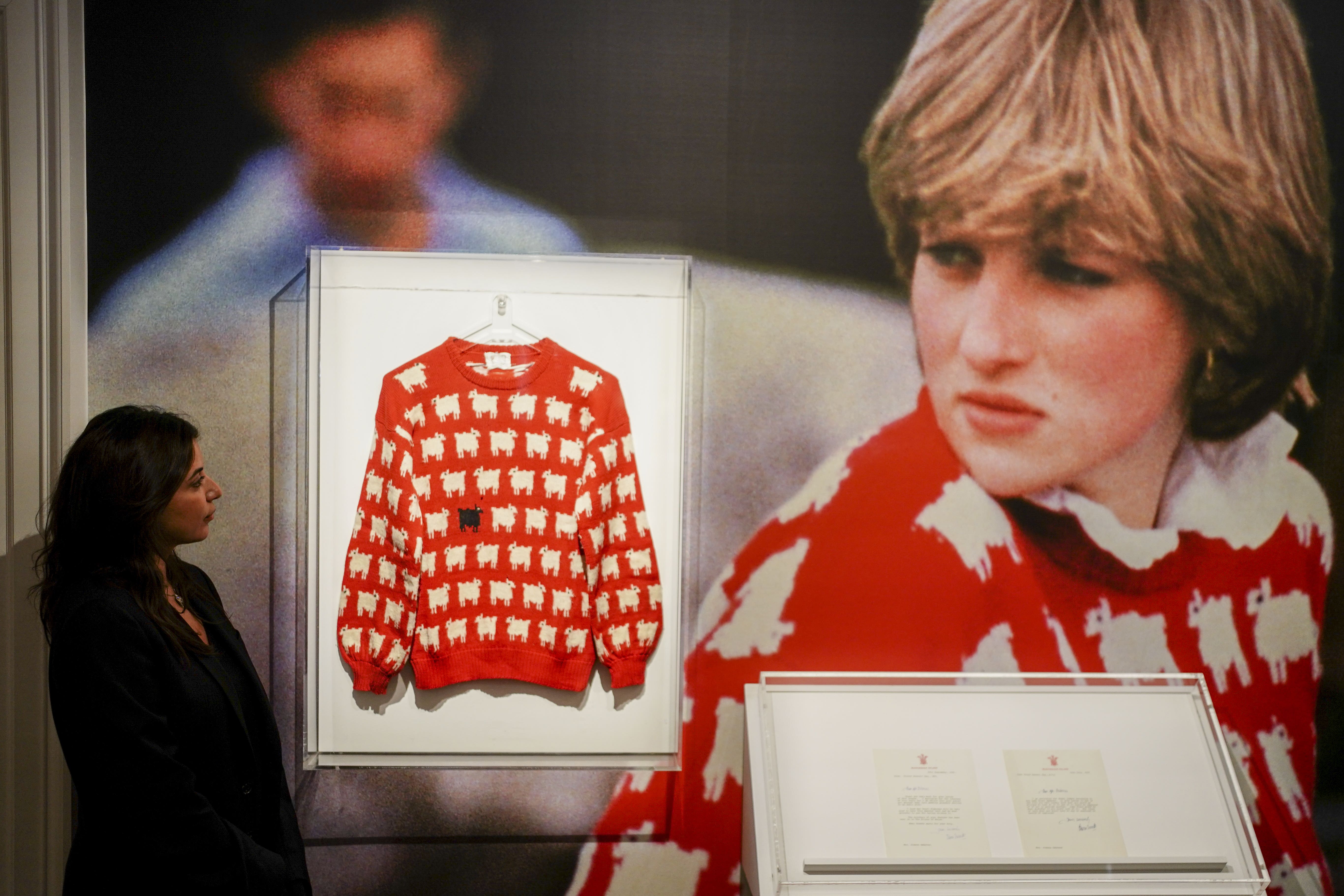 Nezha Bernoussi, marketing and communication associate at Sotheby’s looks at the late Diana, Princess of Wales’ black sheep jumper on display at Sotheby’s, central London, ahead of its sale as part of the auction house’s inaugural Fashion Icons sale in New York in September. The jumper, which she wore on several occasions, is estimated to sell for $50,000-$80,000 (�40,000-�70,000 pounds sterling), with online bidding open from August 31 to September 14. Picture date: Monday July 17, 2023.