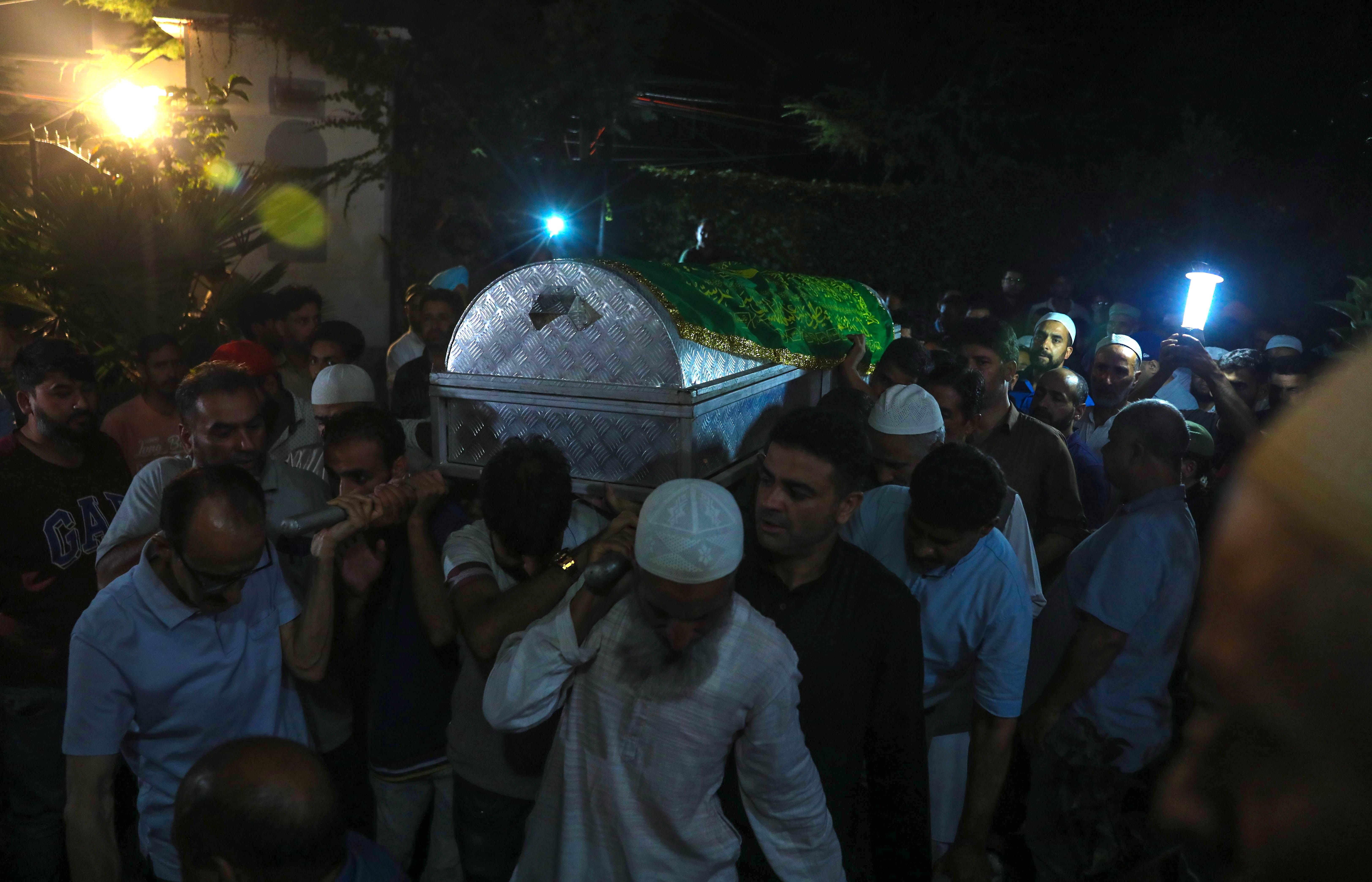 People carry the coffin containing the body of slain Deputy Superintendent (DSP) of Police Humayun Bhat